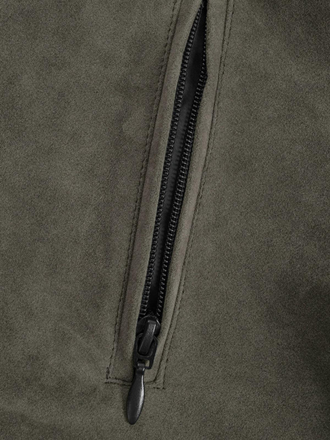 Focusing on the TALISHKO suede jacket's pocket zipper, highlighting its sleek, durable design.