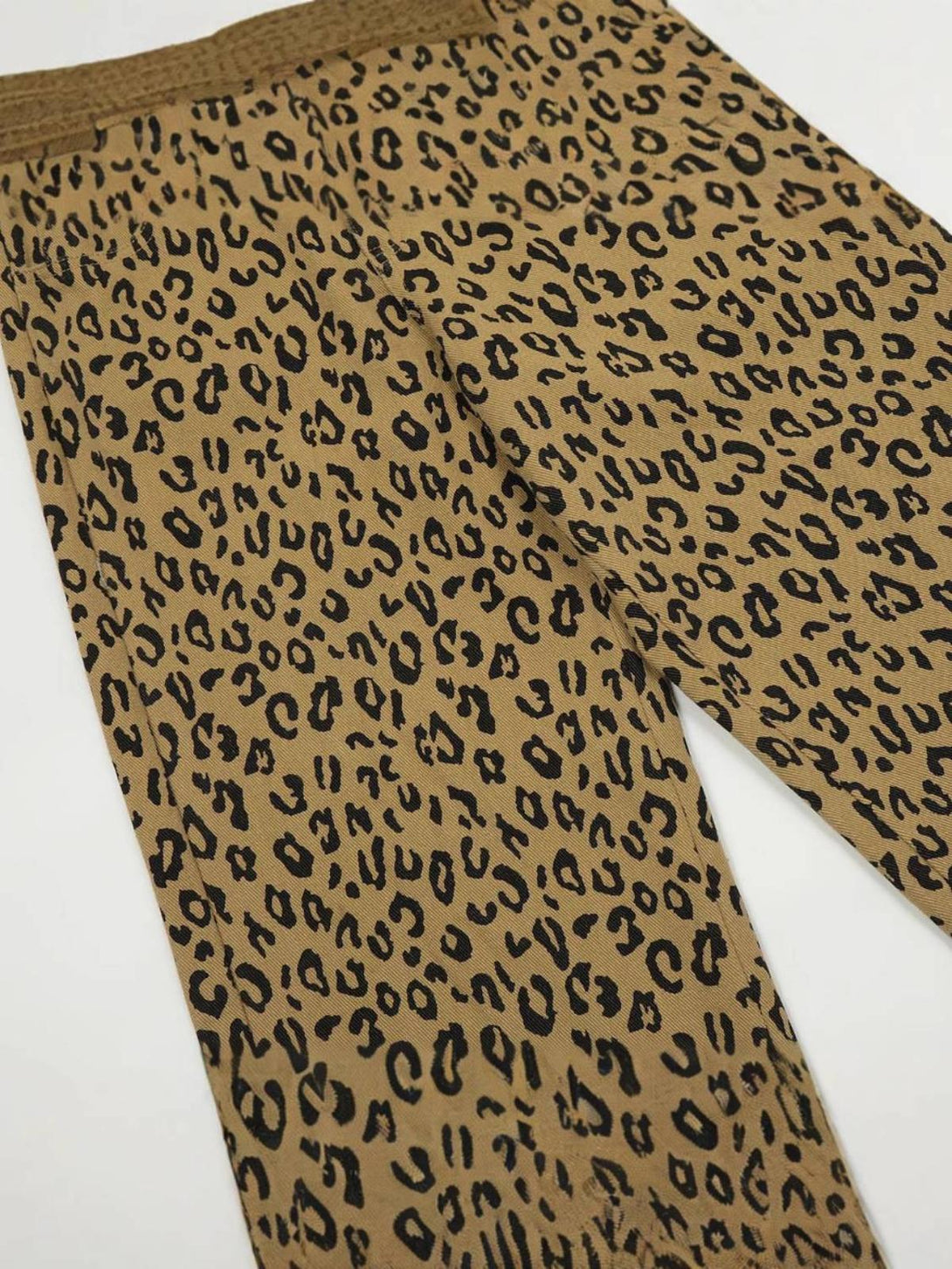 A close-up of TALISHKO vintage leopard print pants, highlighting the intricate pattern.