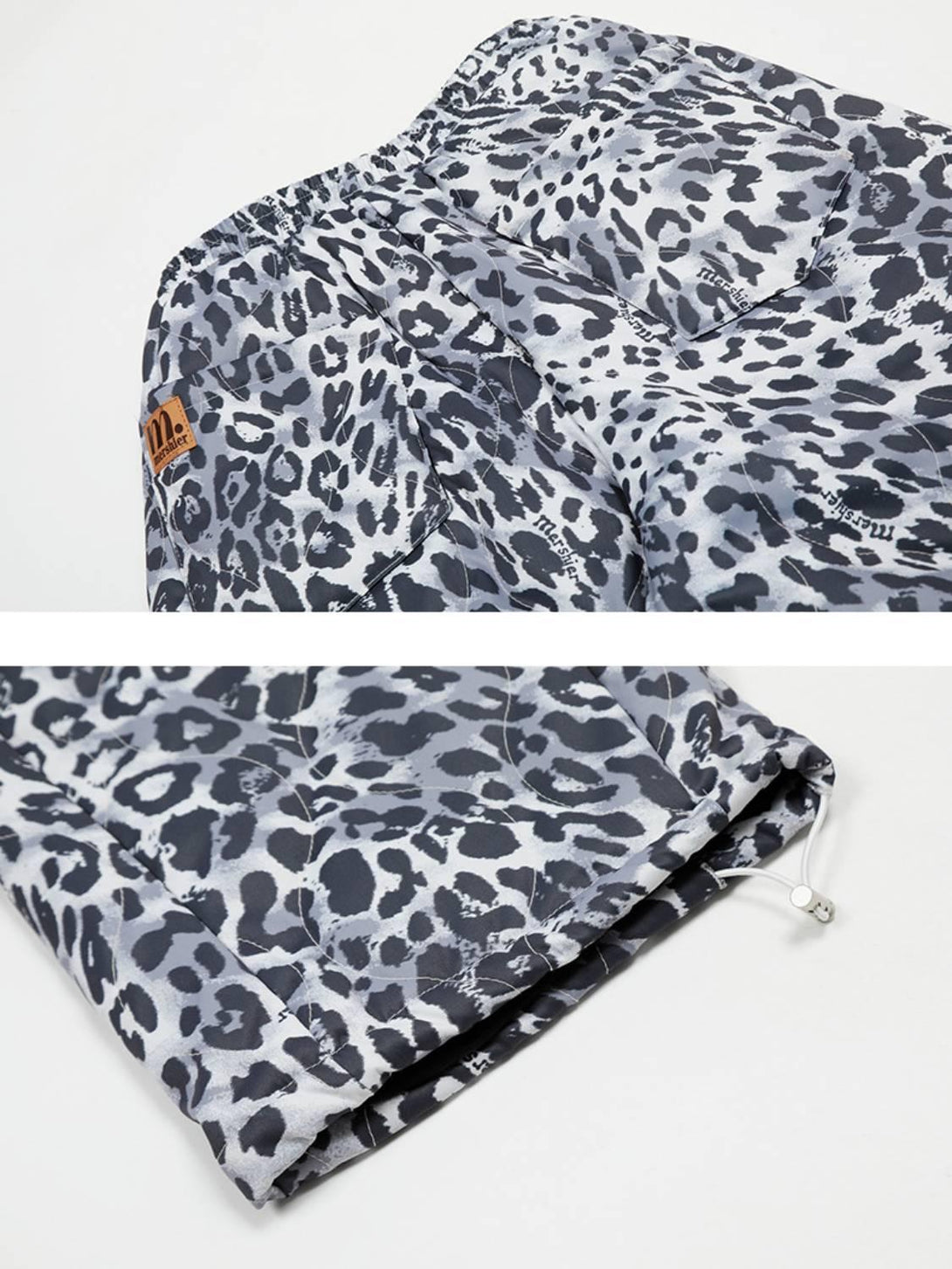 Intricate look at TALISHKO leopard print sweatpants, highlighting detailed texture and hem design.