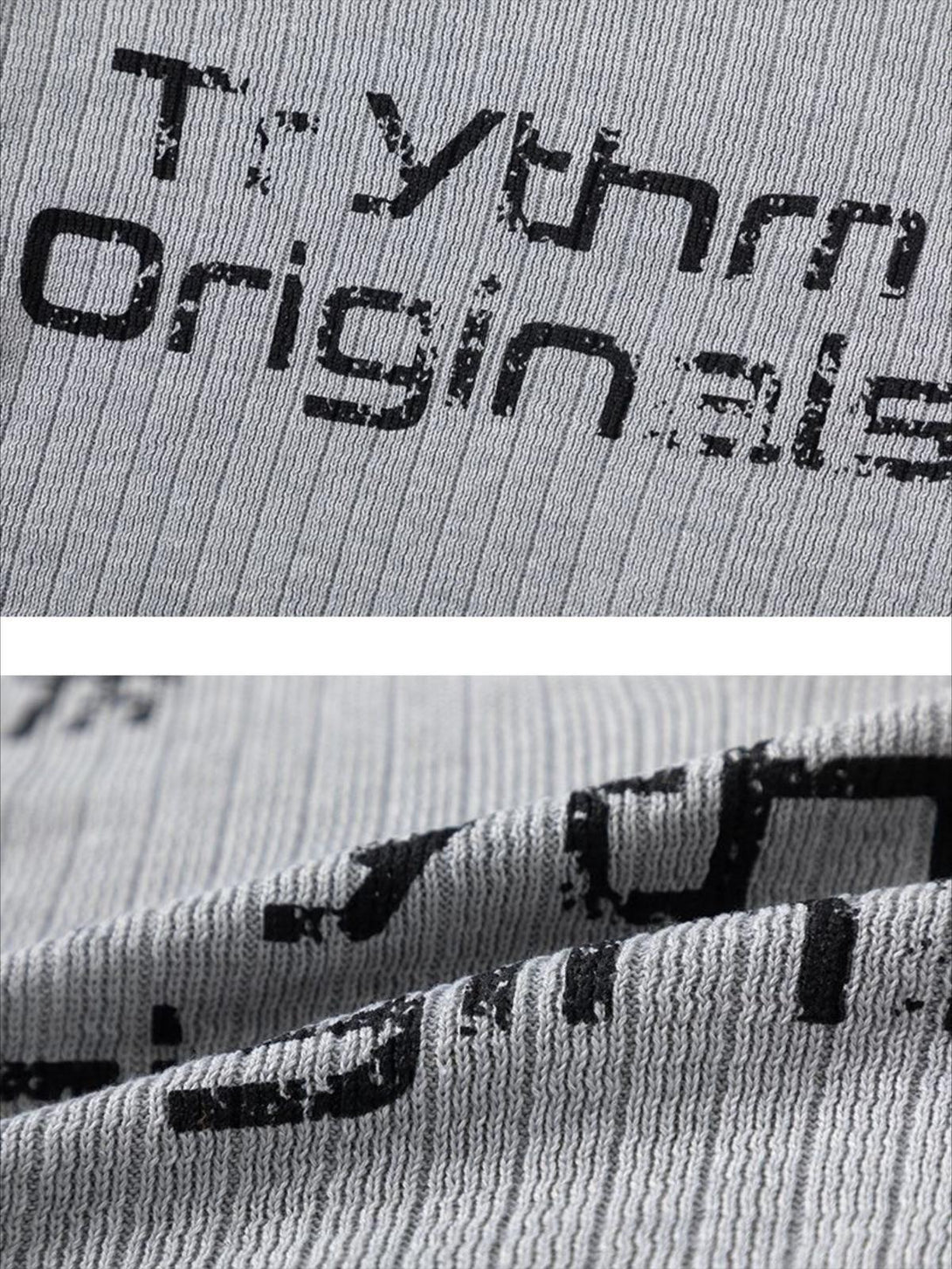Zoomed-in texture of a gray V-neck sweater by TALISHKO, featuring bold lettering detail.