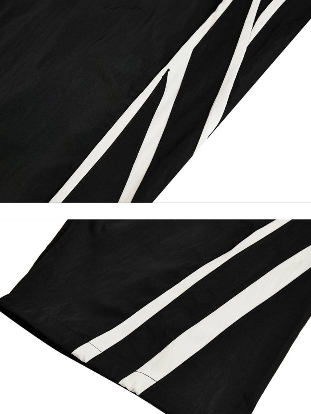 A detailed view of TALISHKO black sweatpants showcasing bold white side stripes.
