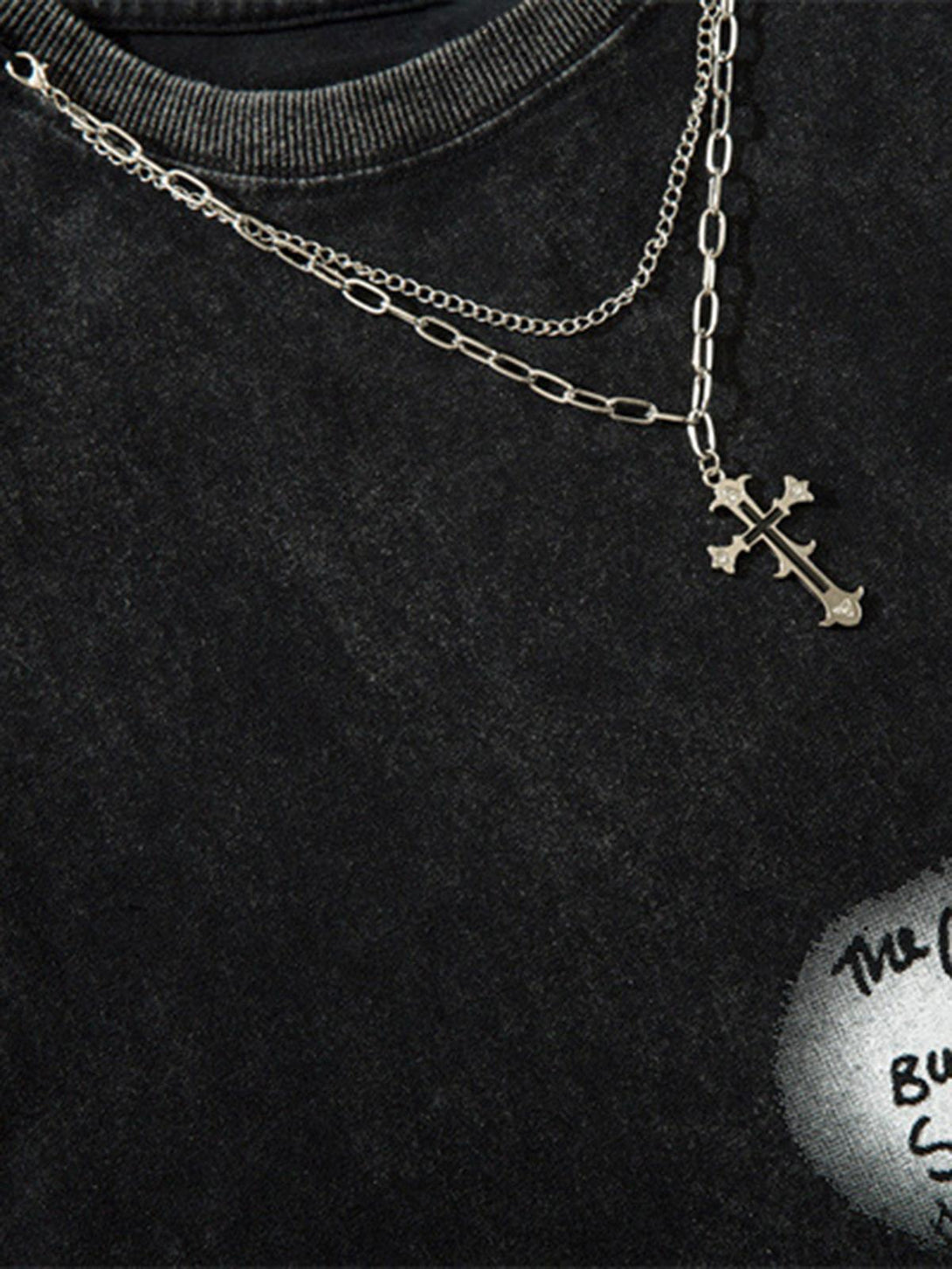 A detailed view of TALISHKO's layered necklace on a vintage-inspired hip-hop tank top.