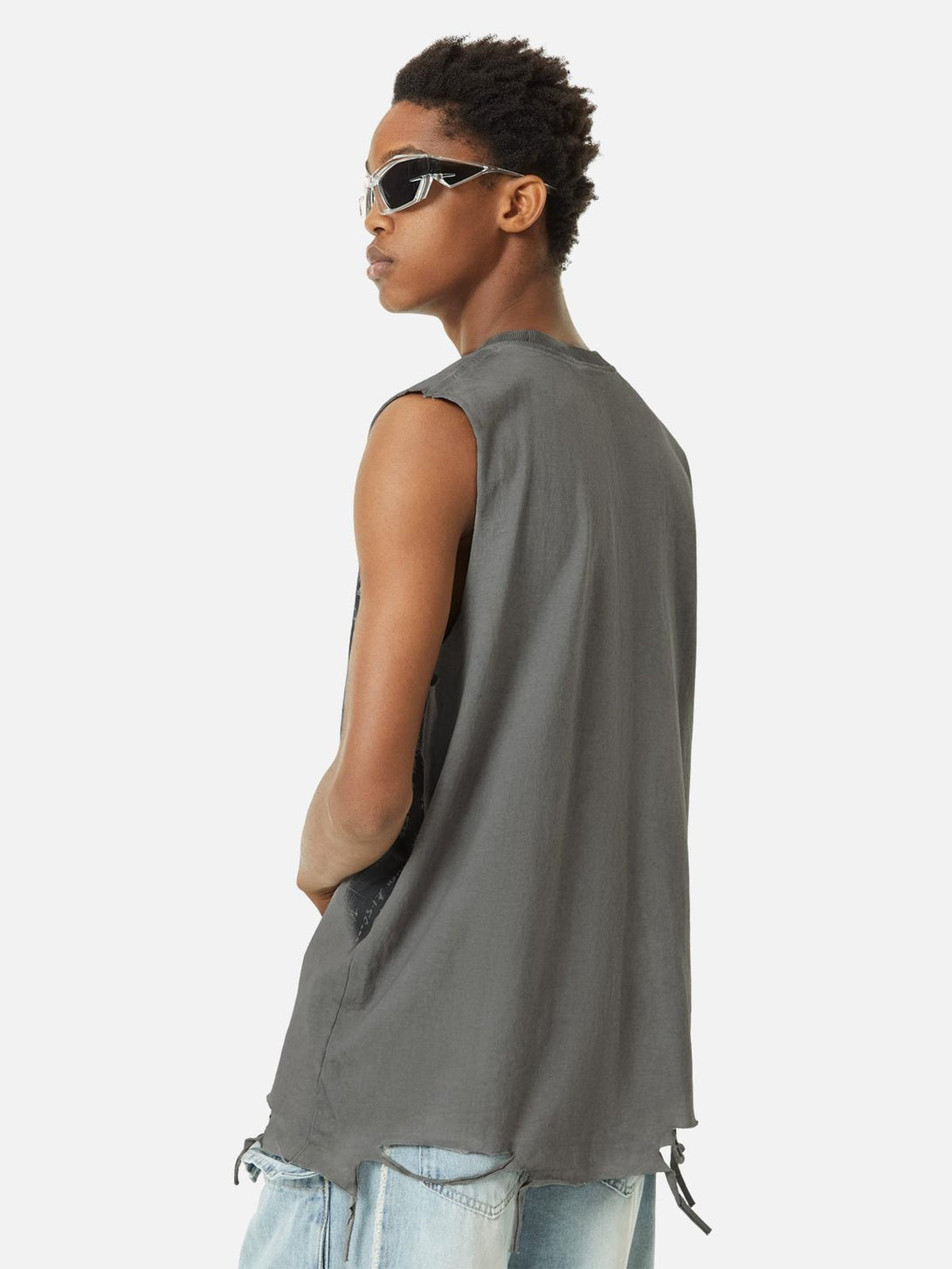 Back view of model in TALISHKO gray hip-hop tank top, styled with edgy sunglasses.