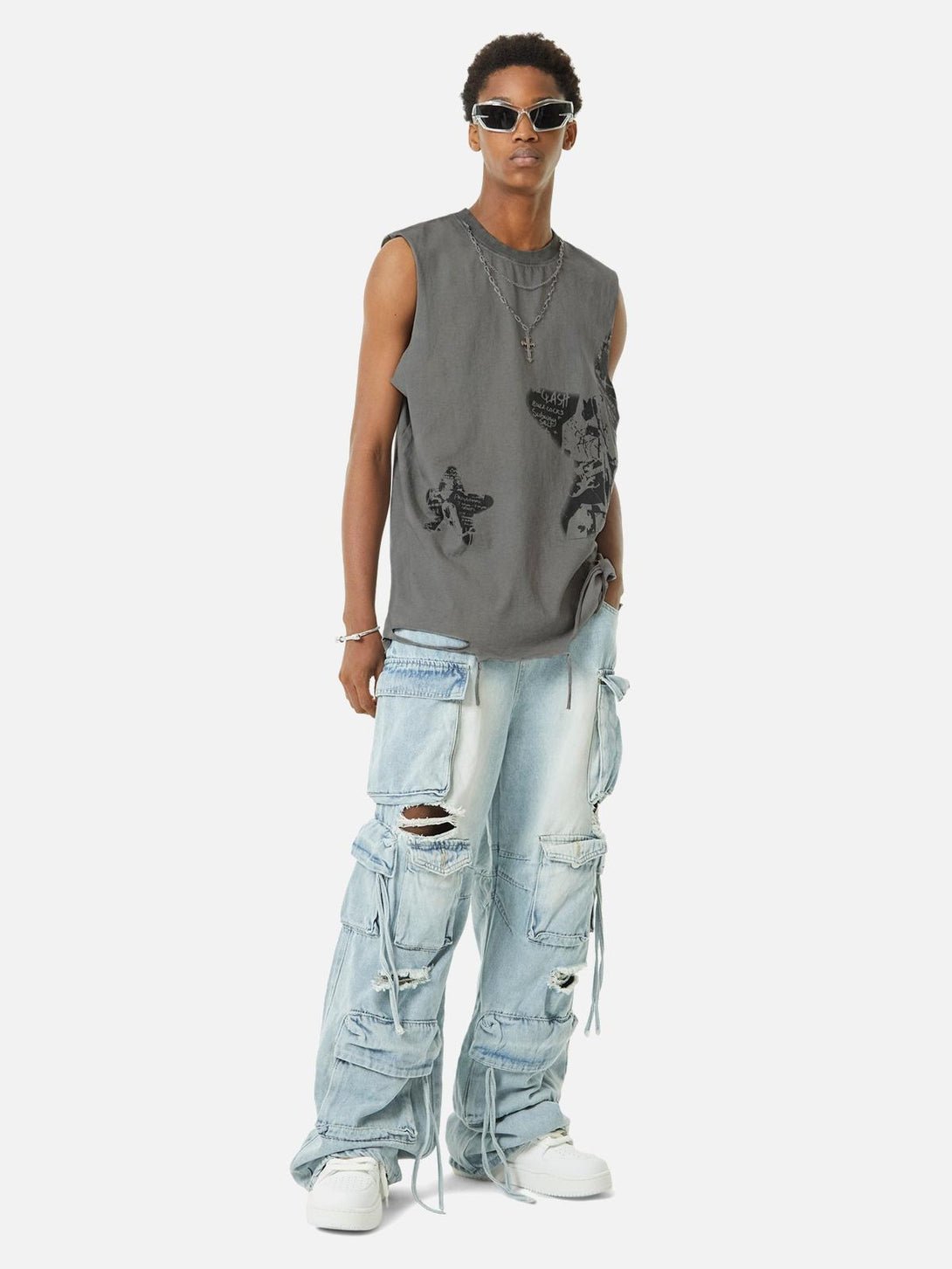 Model in TALISHKO tank top with vintage star print, layered necklaces, and distressed jeans.