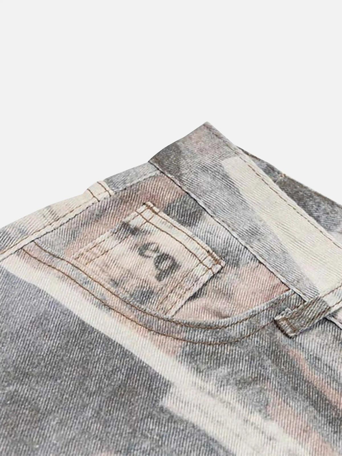 Intricate look at TALISHKO's vintage newspaper print pants, highlighting back pocket details.