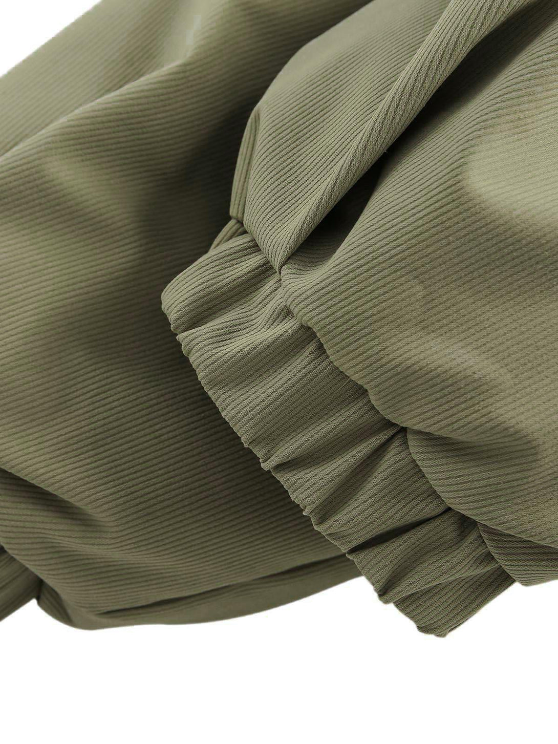 Zoomed-in view of green pleated sleeve detail on TALISHKO's oversized vintage jacket.