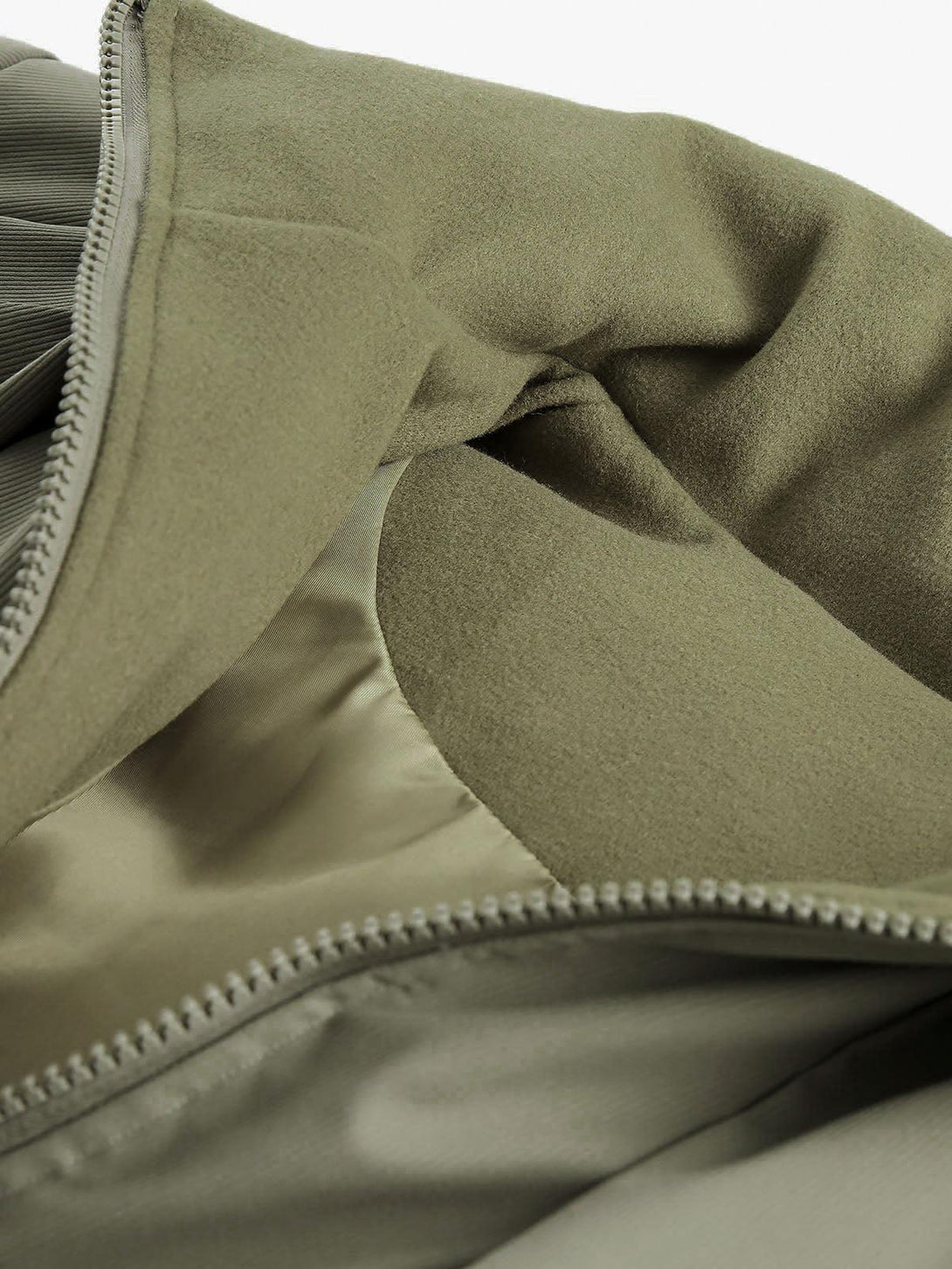 A detailed view of the interior fabric and zipper of a TALISHKO vintage oversized jacket.