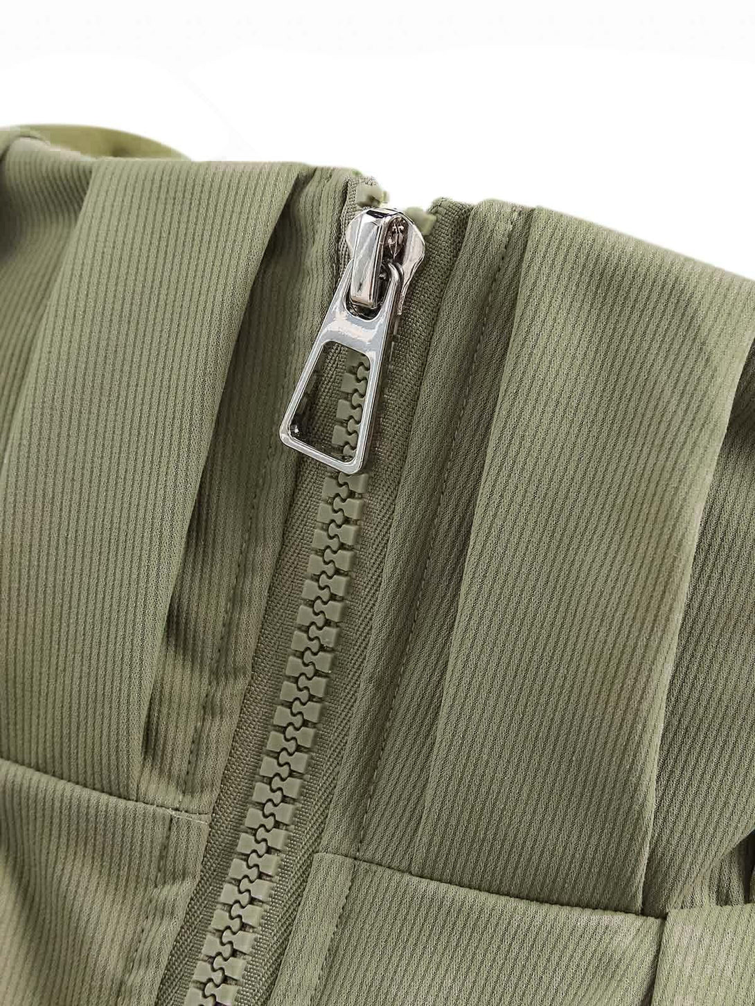 A detailed look at the green pleated fabric and zipper of a TALISHKO vintage oversized jacket.