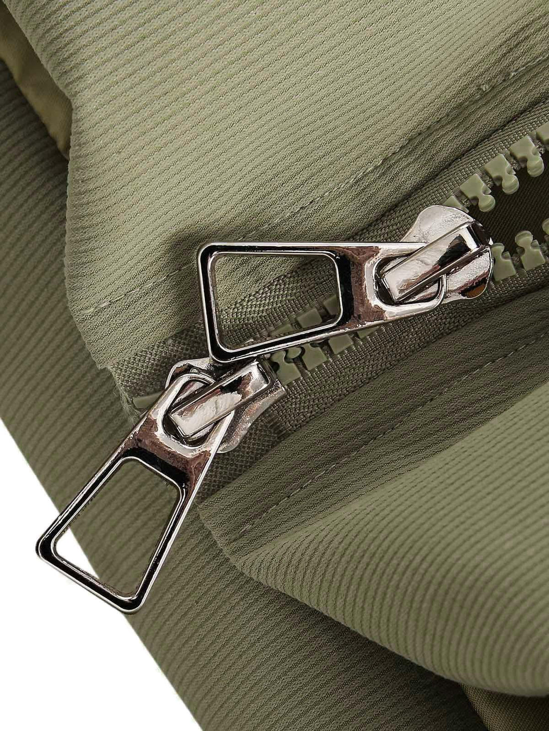 Detailed view of dual zippers on TALISHKO's vintage oversized jacket in green fabric.