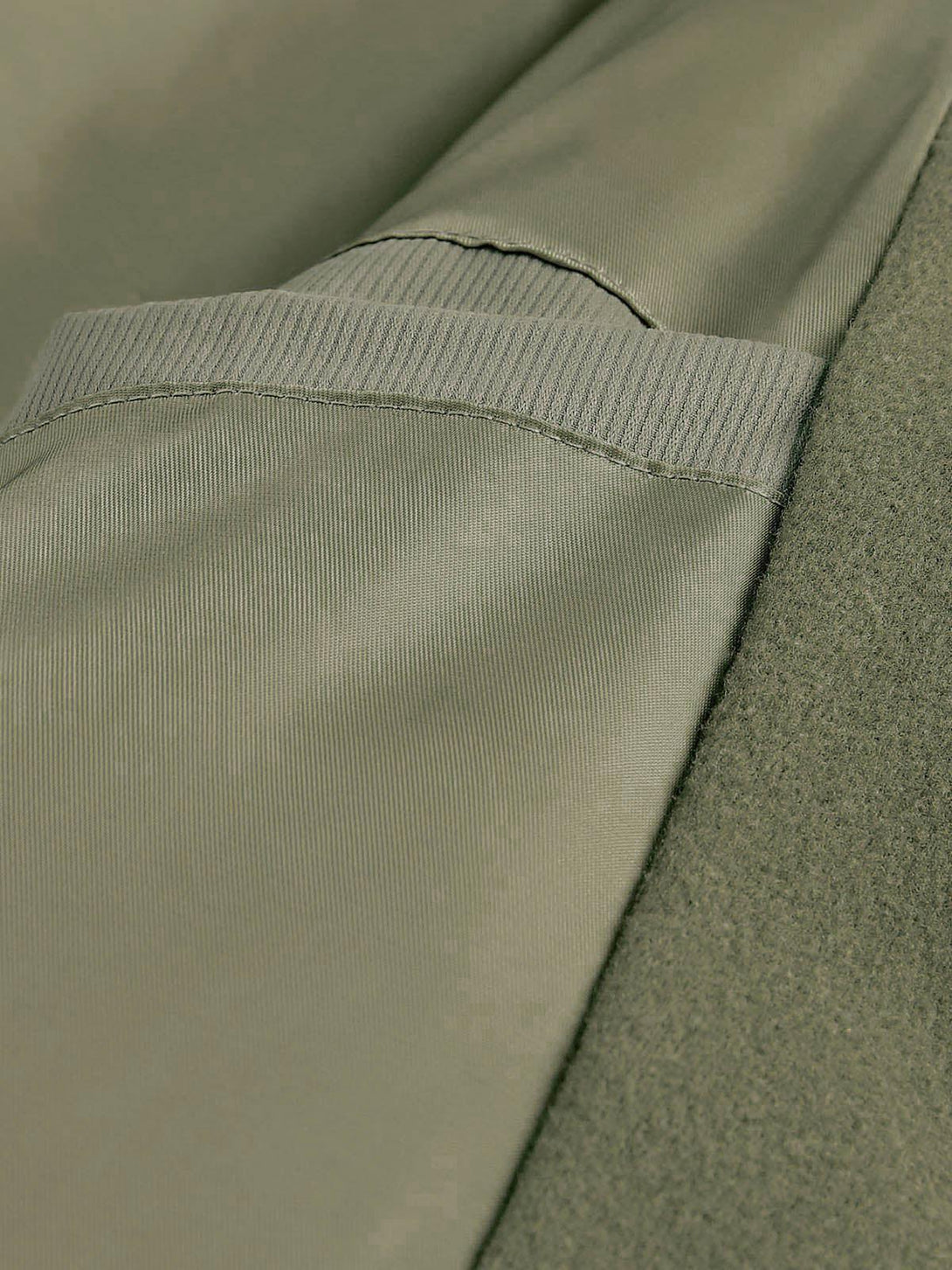 Detailed fabric and stitching of TALISHKO's vintage oversized pleated stand collar jacket.