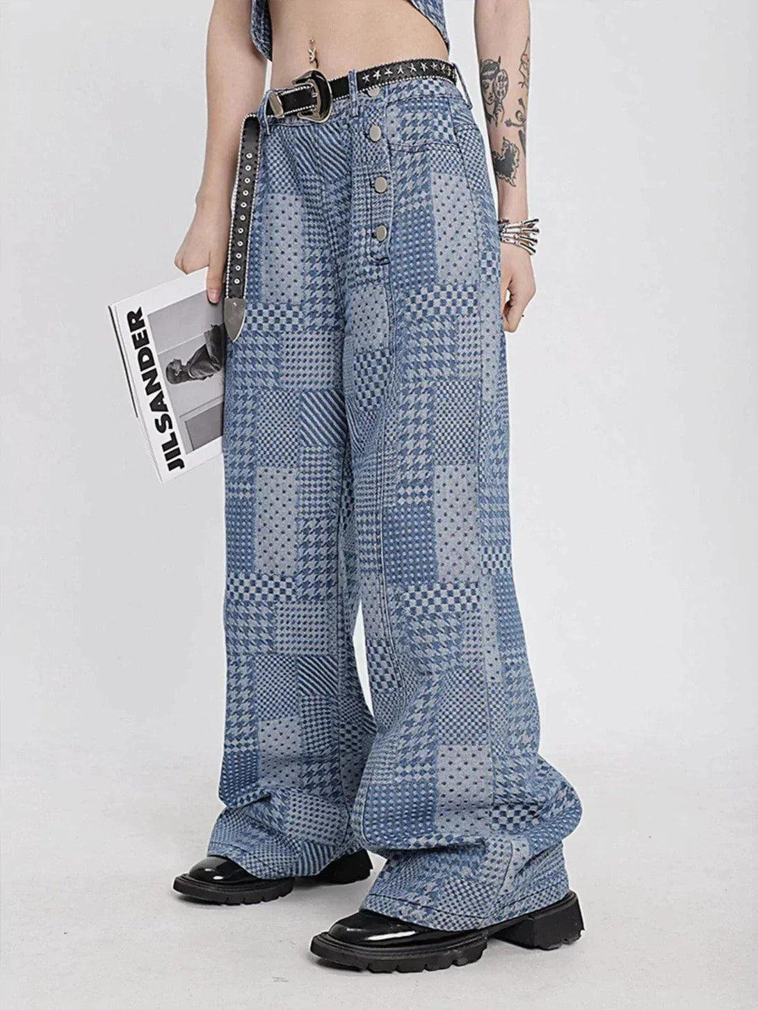 Model wearing vintage patchwork jeans by TALISHKO, showcasing unique blue patterns and a relaxed fit.