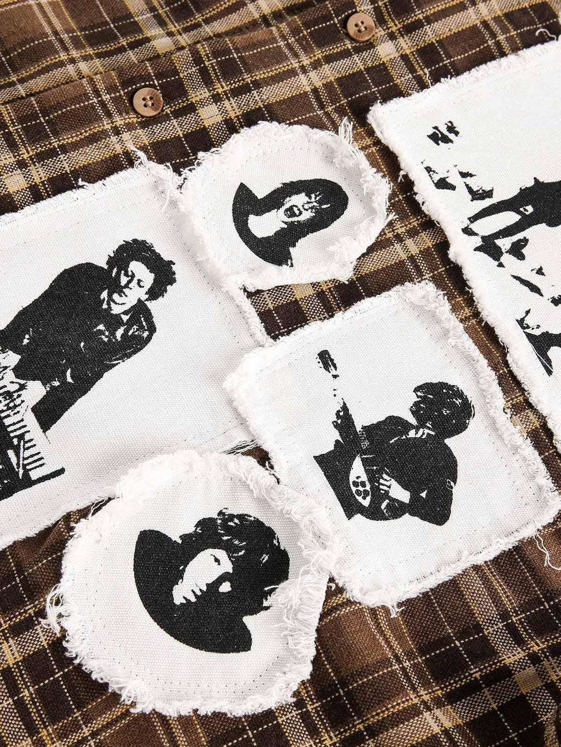 Brown plaid shirt by TALISHKO featuring vintage portrait appliques, highlighting unique design details.