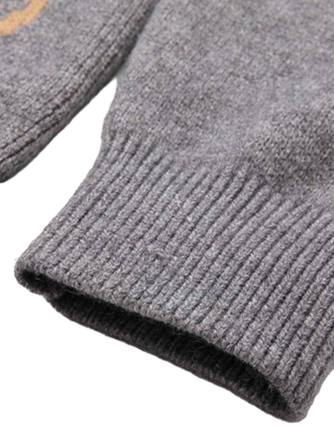 Zoomed-in texture of a gray knit sweater cuff by TALISHKO, showcasing its ribbed detail.