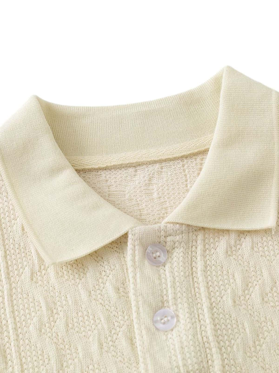 A detailed view of the textured knit and buttons on a polo shirt by TALISHKO.