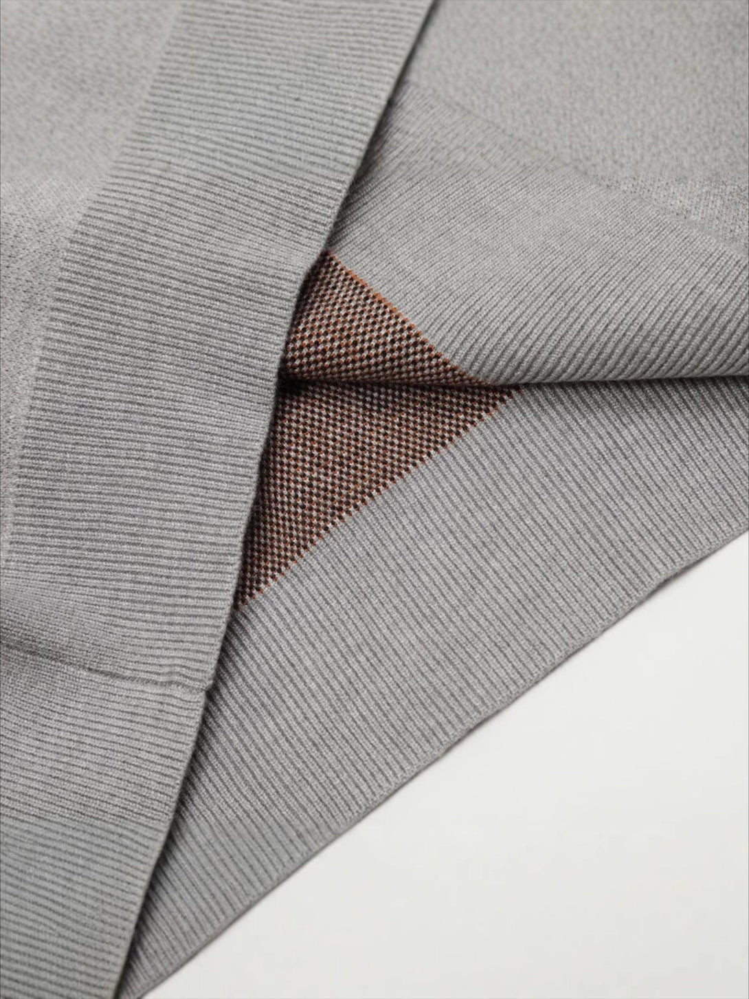 A detailed look at TALISHKO's vintage knit cardigan, highlighting its unique texture and design.