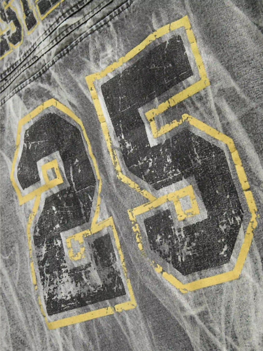 Bold number 25 design on TALISHKO's distressed vintage racing jacket, highlighting texture details.