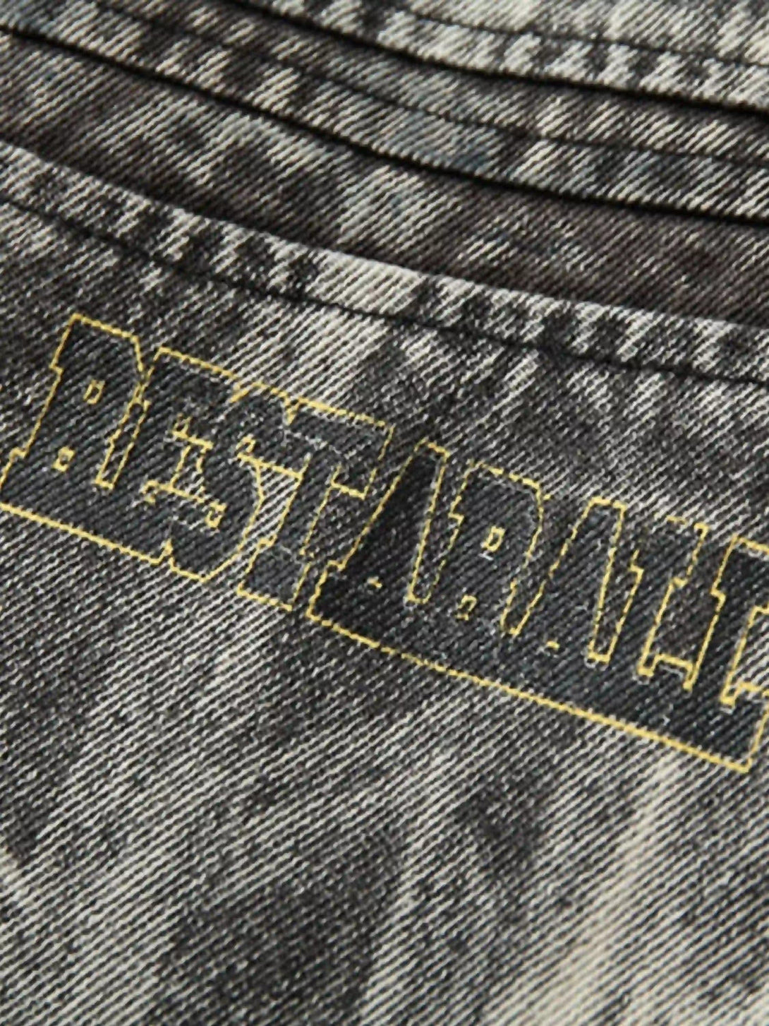 Detailed fabric and stitching on TALISHKO's vintage racing jacket, highlighting distressed texture.