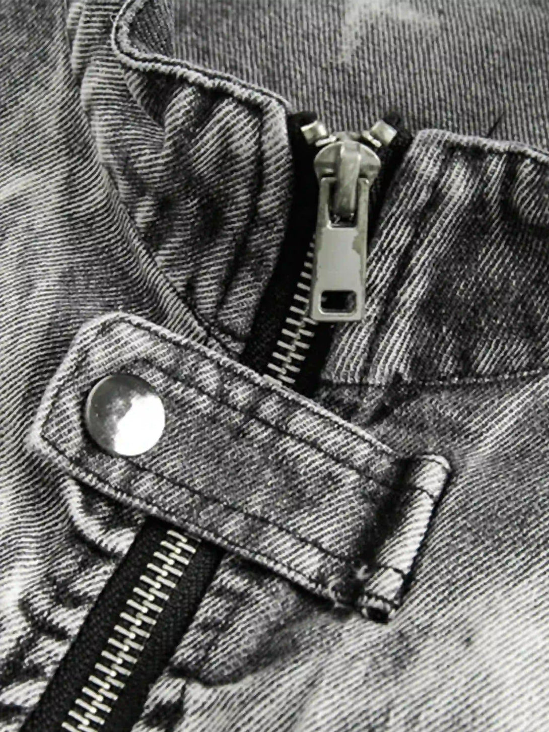 Intricate look at TALISHKO's vintage racing jacket zipper and button details, showcasing texture.