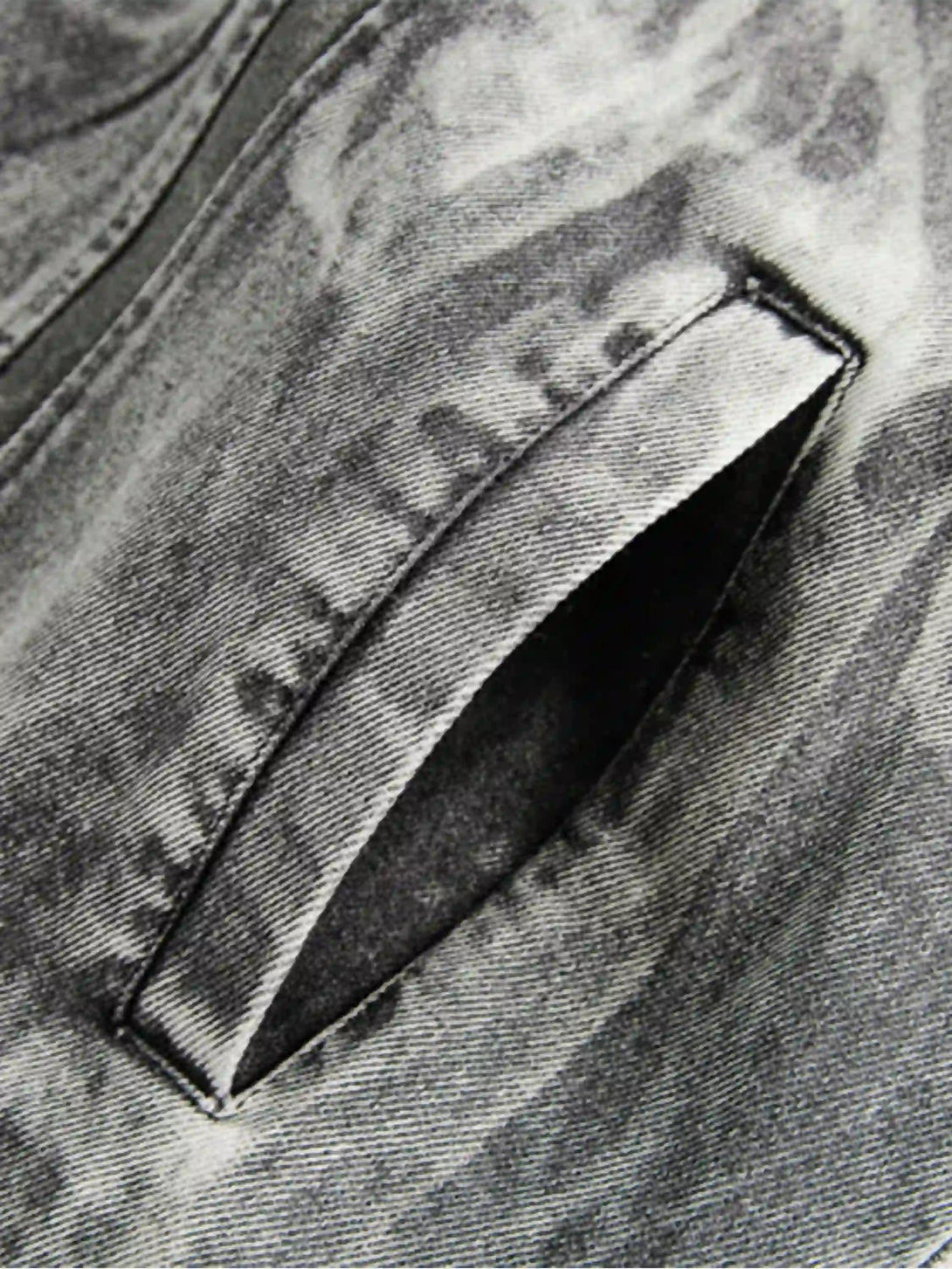 Intricate look at TALISHKO's vintage jacket pocket, highlighting distressed texture.