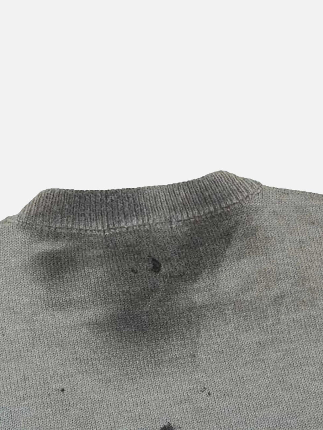 A detailed look at the distressed collar on TALISHKO's vintage tie-dye sweater.