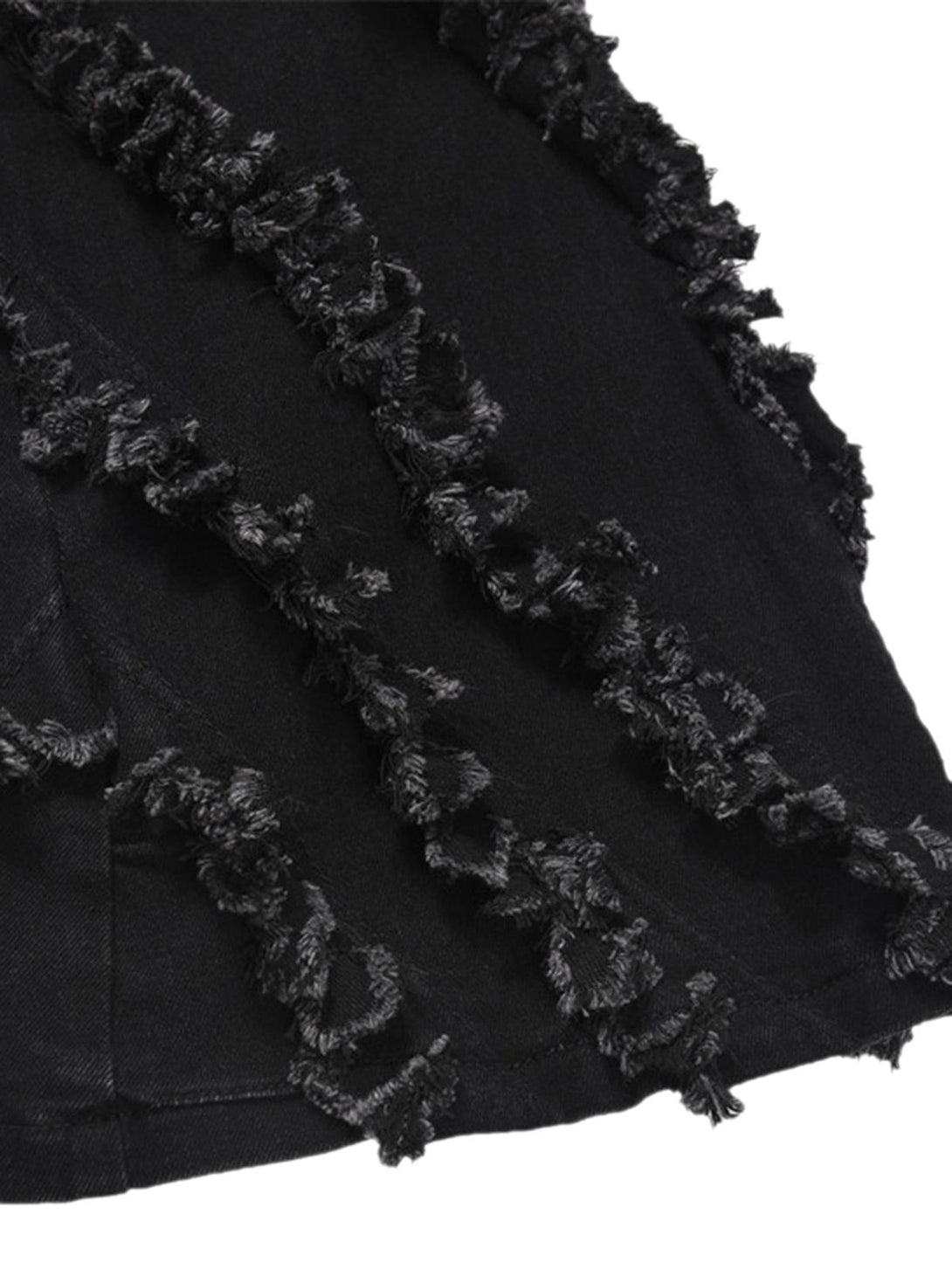 Intricate look at TALISHKO's vintage flared jeans, highlighting unique rough-edge details.