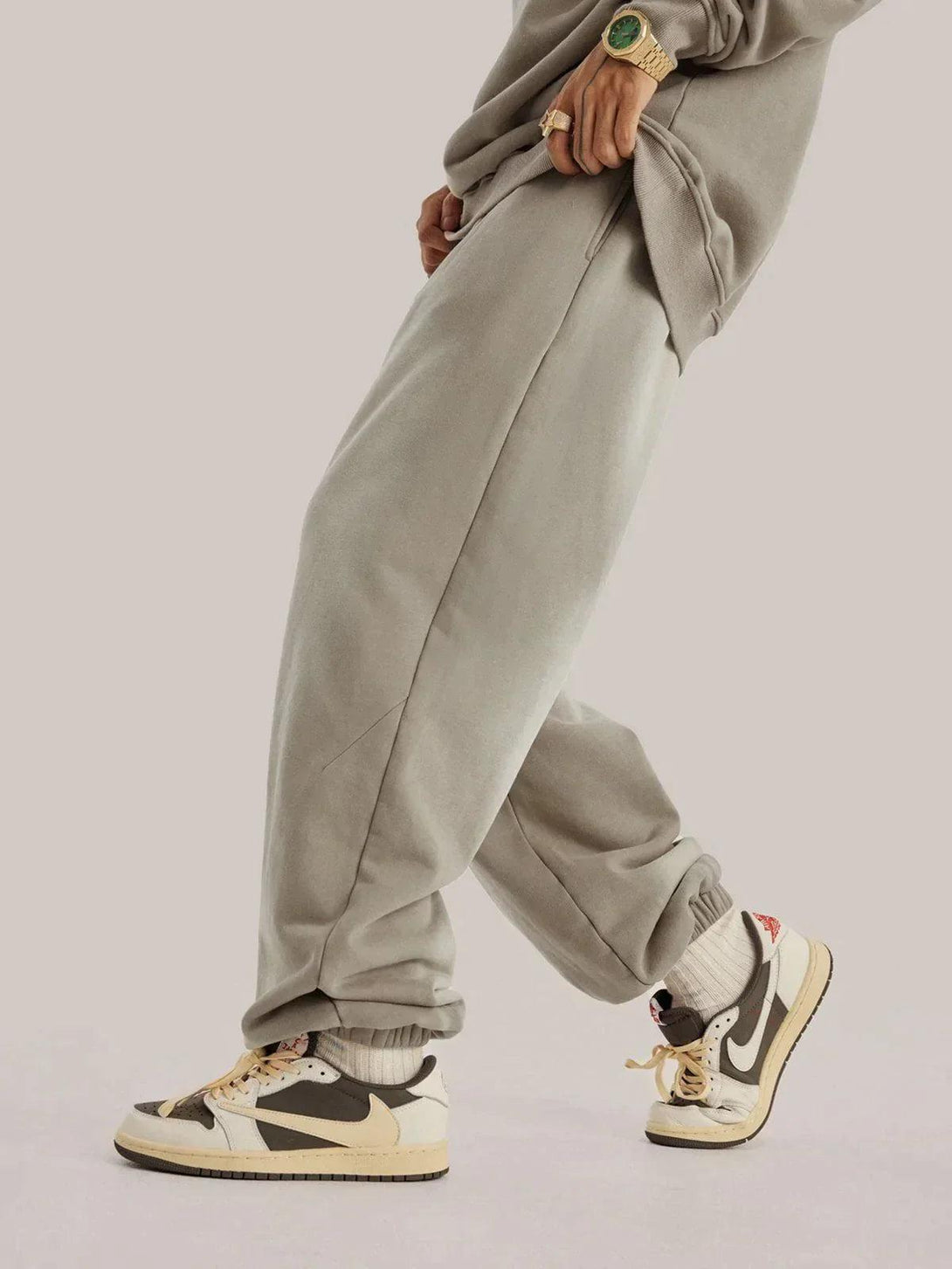 Casual style with TALISHKO vintage smudged pants and trendy sneakers for a relaxed vibe.