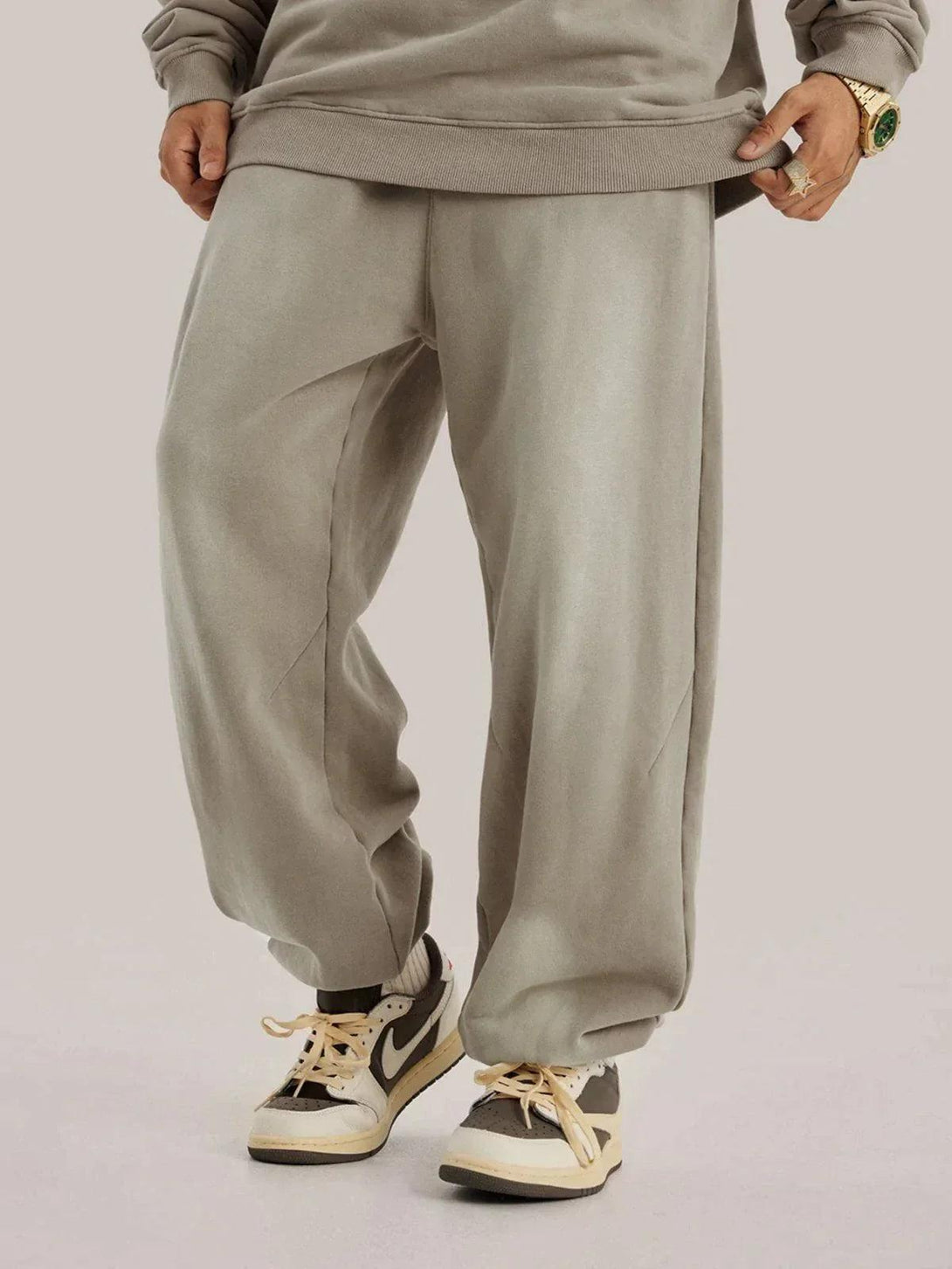 Model wearing TALISHKO vintage smudged pants, paired with stylish sneakers for a casual look.