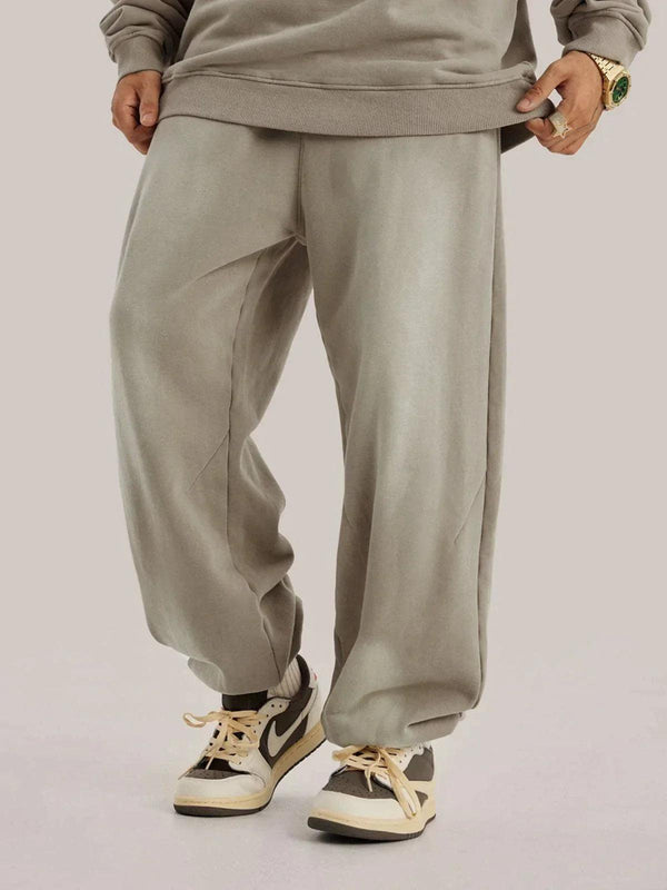 Model wearing TALISHKO vintage smudged pants, paired with stylish sneakers for a casual look.