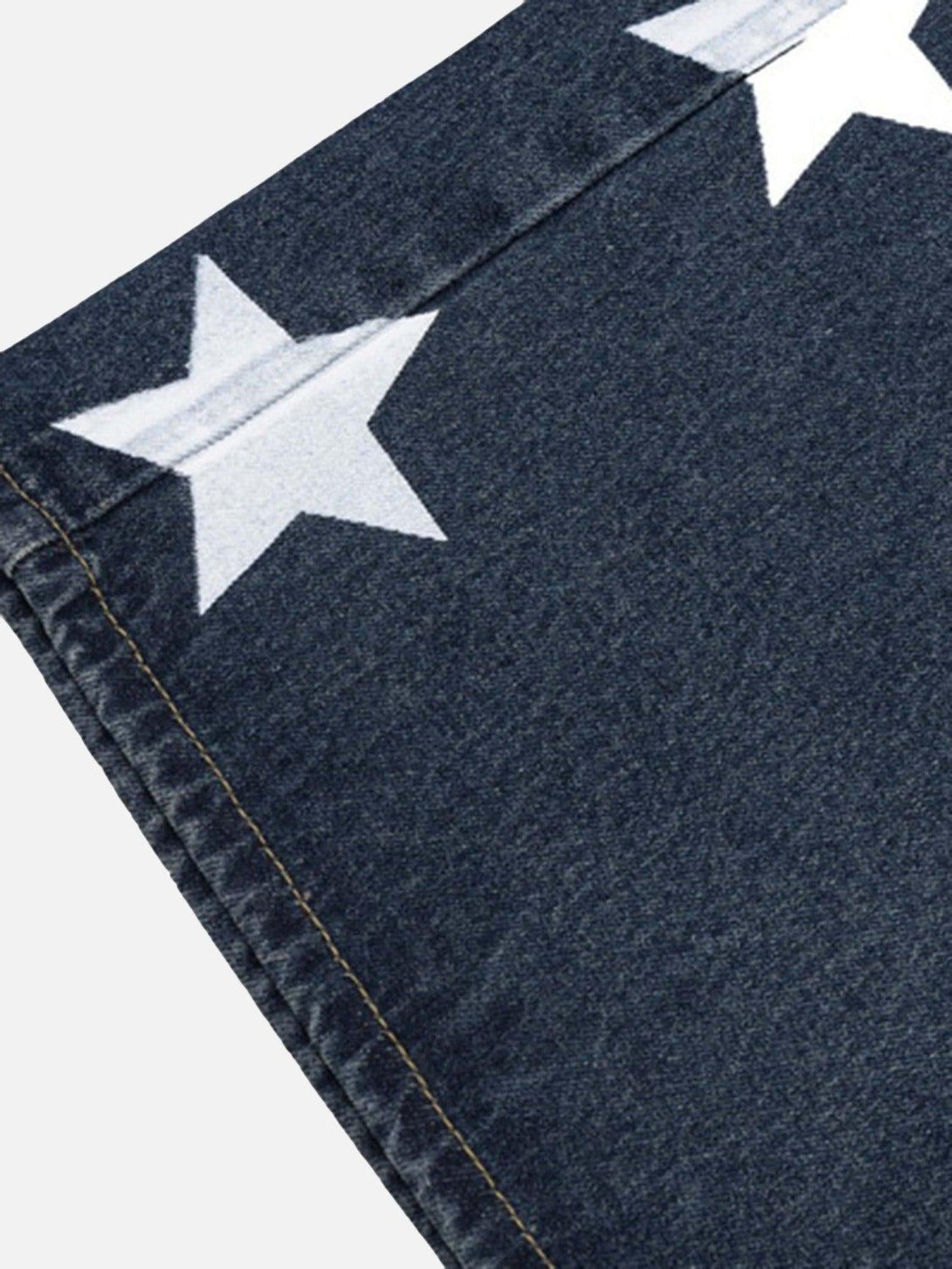 A tight crop highlighting the star pattern on TALISHKO's vintage denim pants for a trendy look.
