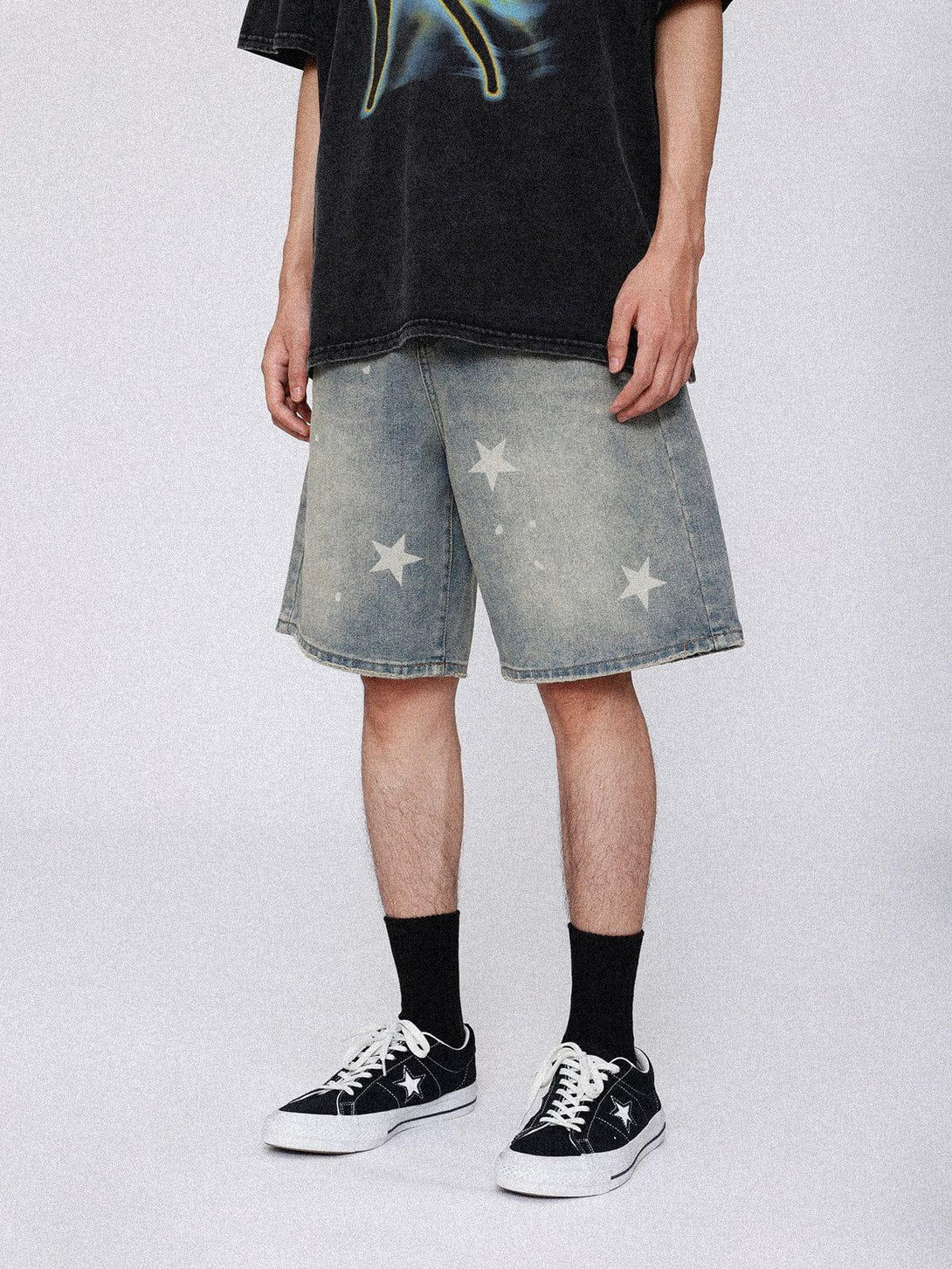 Model in TALISHKO vintage star jorts, paired with sneakers and black socks for a casual look.