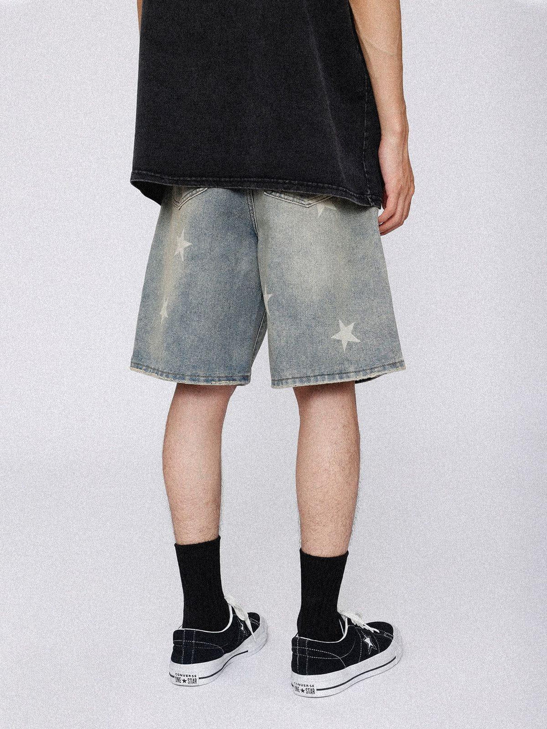 Back view of TALISHKO vintage star jorts, styled with black socks and sneakers for a relaxed look.
