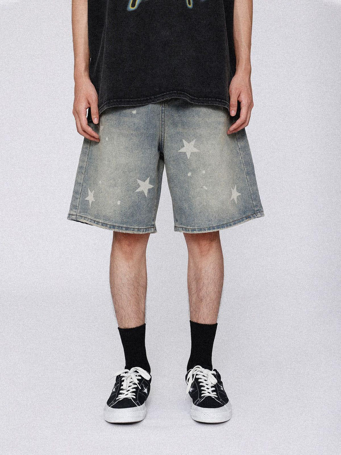 Model wearing TALISHKO vintage star jorts with a subtle star pattern, styled with sneakers.