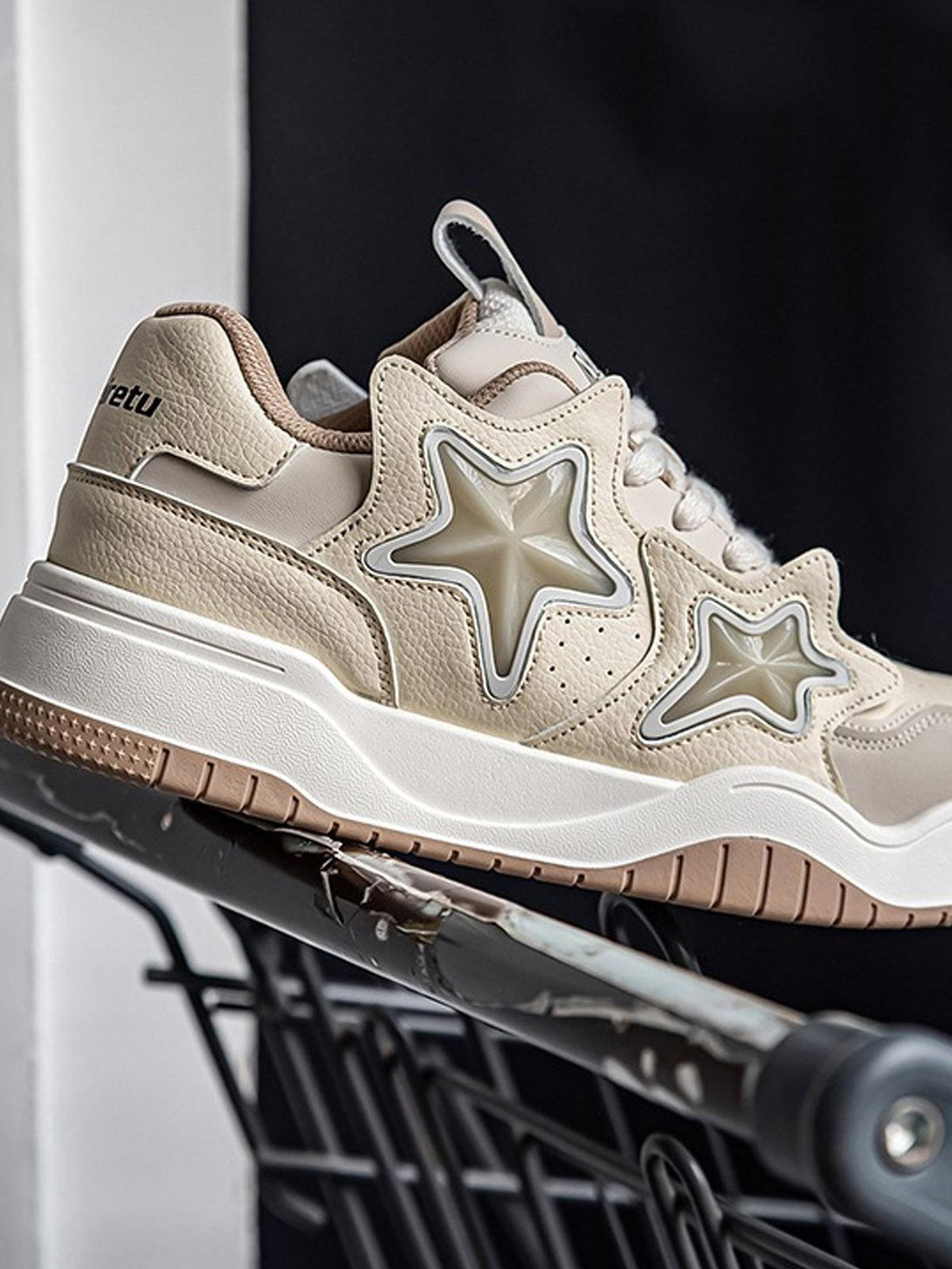 Side view of beige vintage star sneakers by TALISHKO, highlighting unique star details.