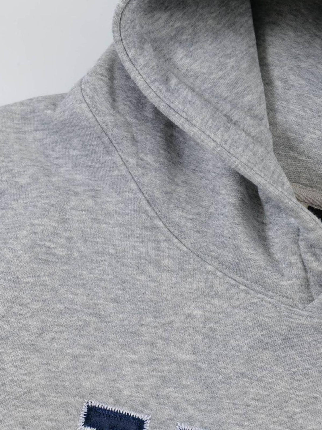 A detailed view of the gray TALISHKO hoodie, highlighting its minimalistic stitching and texture.