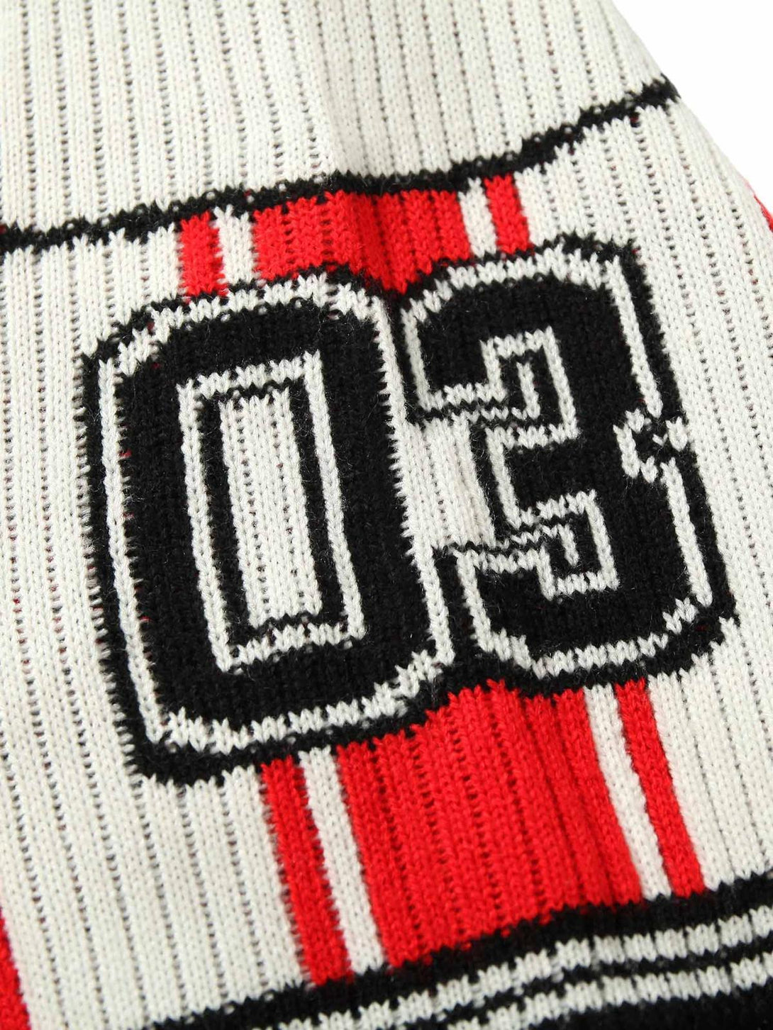 A close-up of TALISHKO's vintage striped knit sweater, showcasing the bold number 03 design.