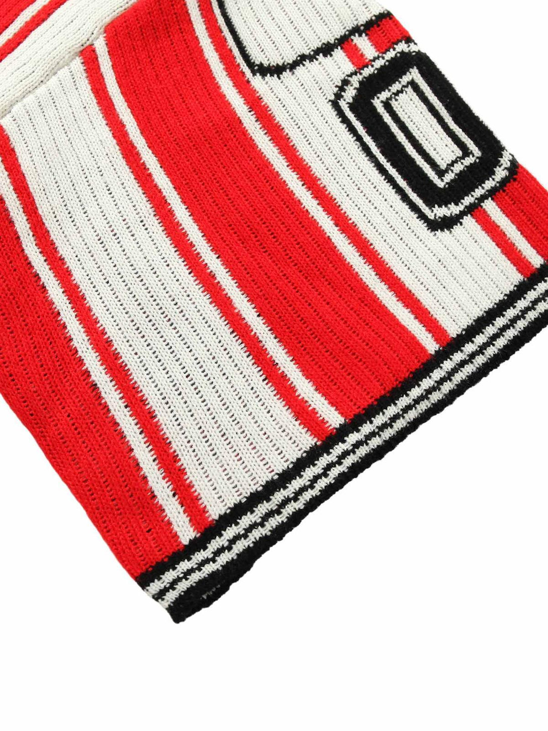 A detailed view of the TALISHKO vintage striped sweater, highlighting bold red and white patterns.
