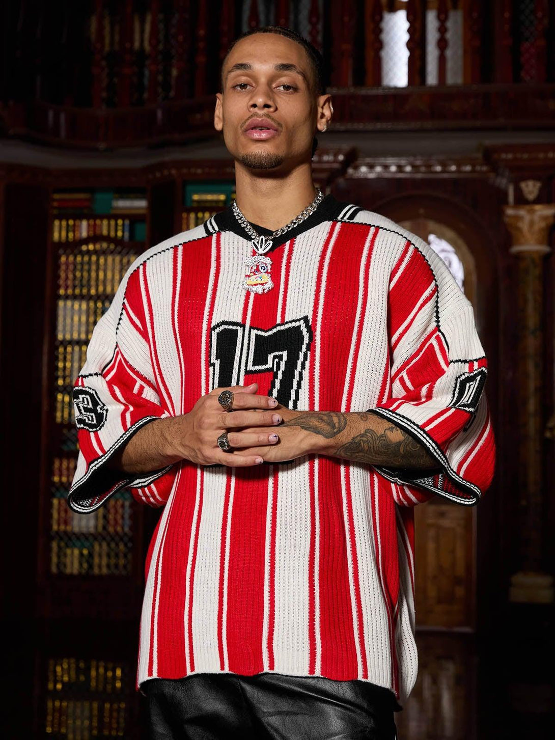 Model wearing TALISHKO vintage striped knit sweater in red and white with bold number details.