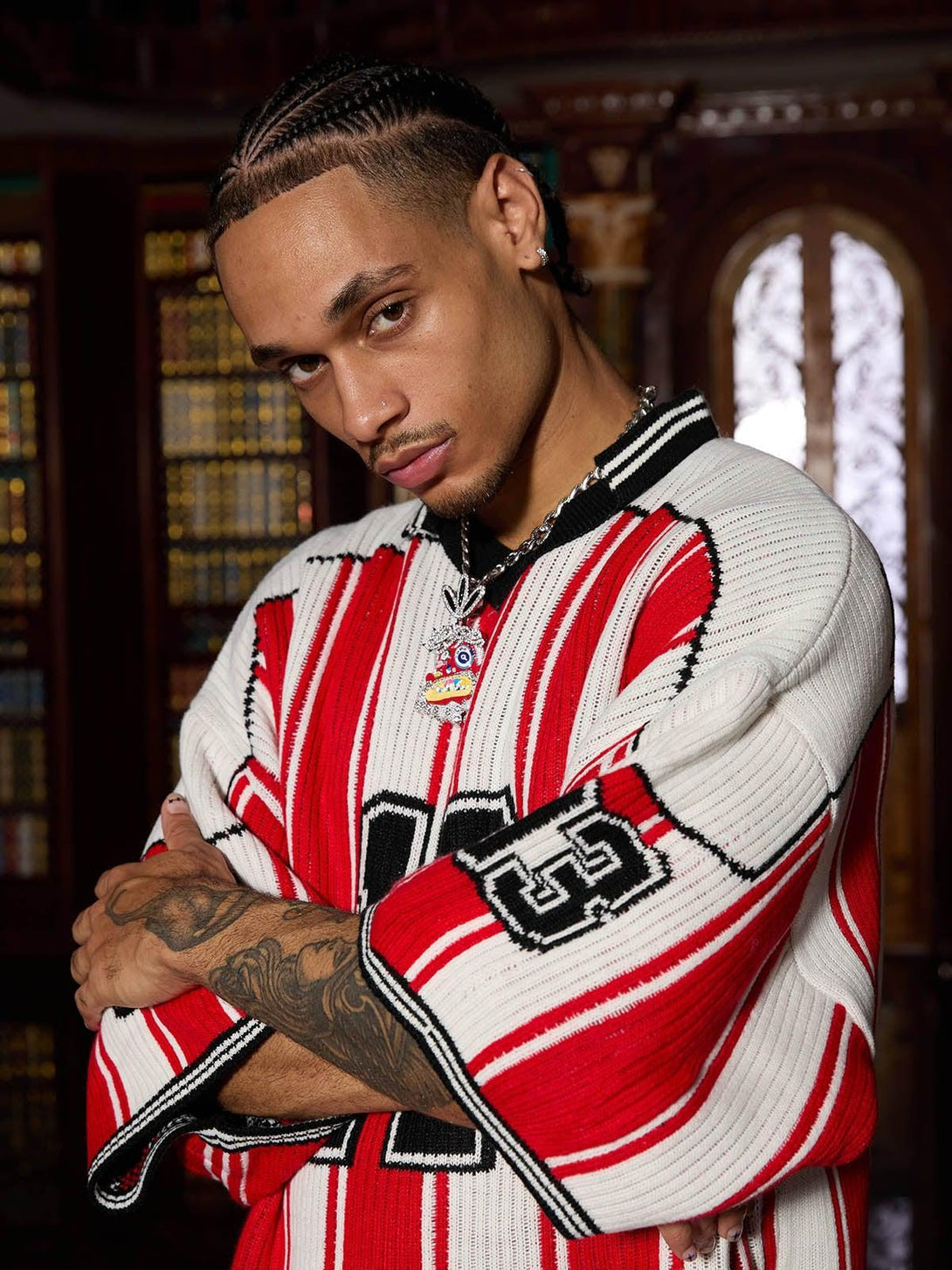 Model wearing TALISHKO's vintage striped knit sweater in red and white, showcasing bold number design.
