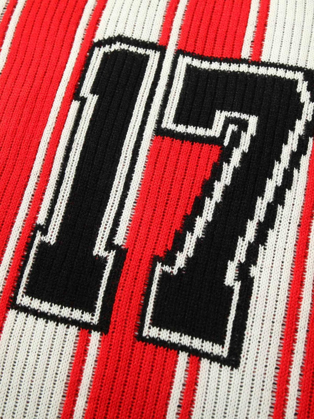 Zoomed-in texture of TALISHKO's vintage striped knit sweater, highlighting the bold number 17.