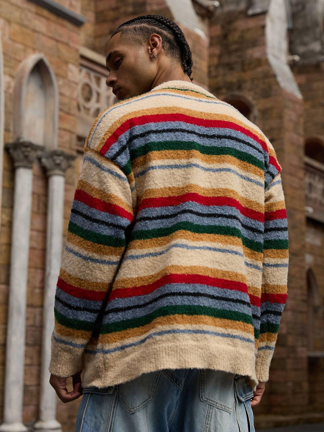Model wearing a vintage striped sweater by TALISHKO, showing the back in an urban setting.