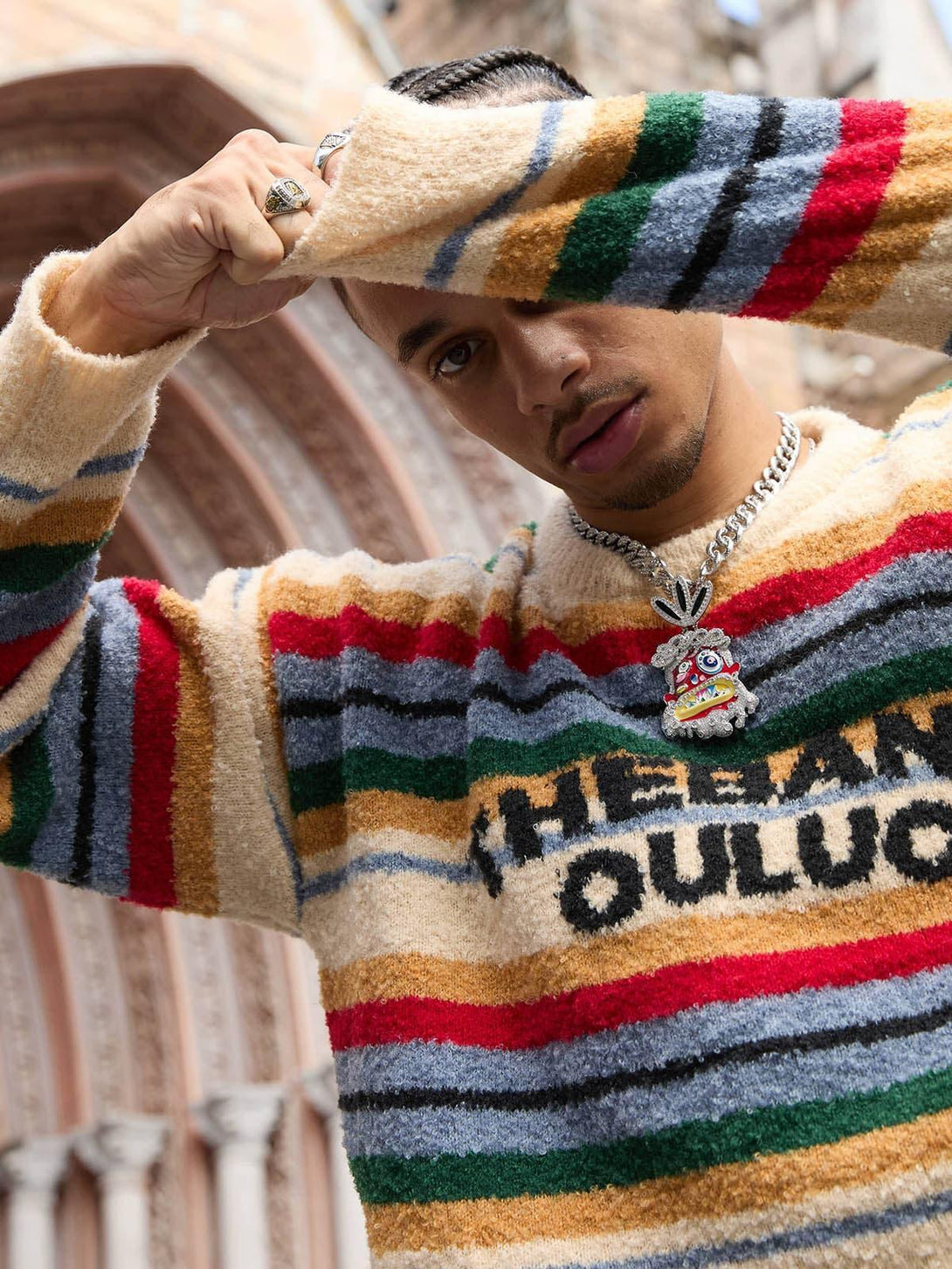 Model in a vintage striped sweater by TALISHKO, highlighting bold colors and urban style.
