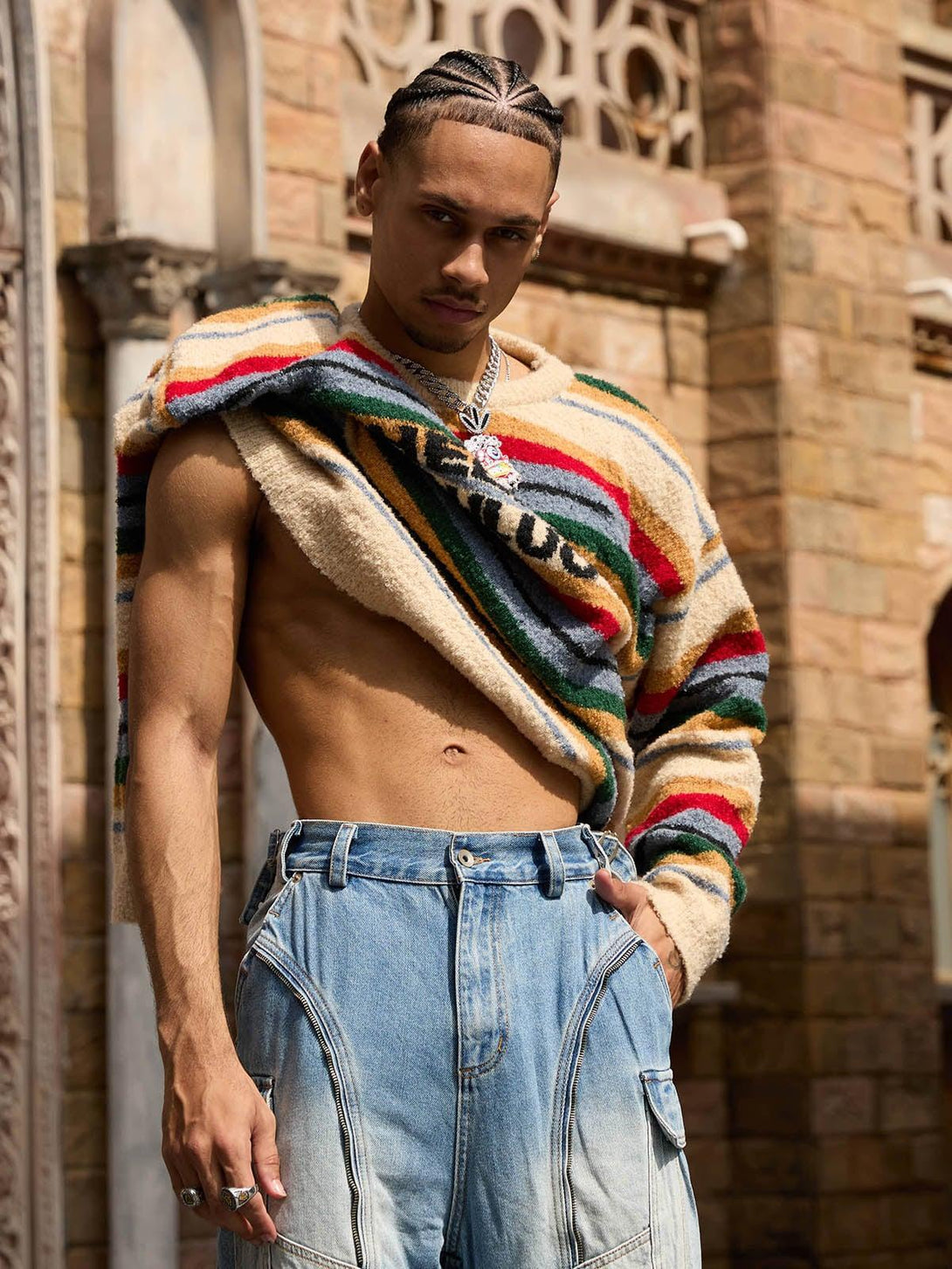 Model styled in a vintage striped sweater by TALISHKO, paired with denim, in an urban backdrop.