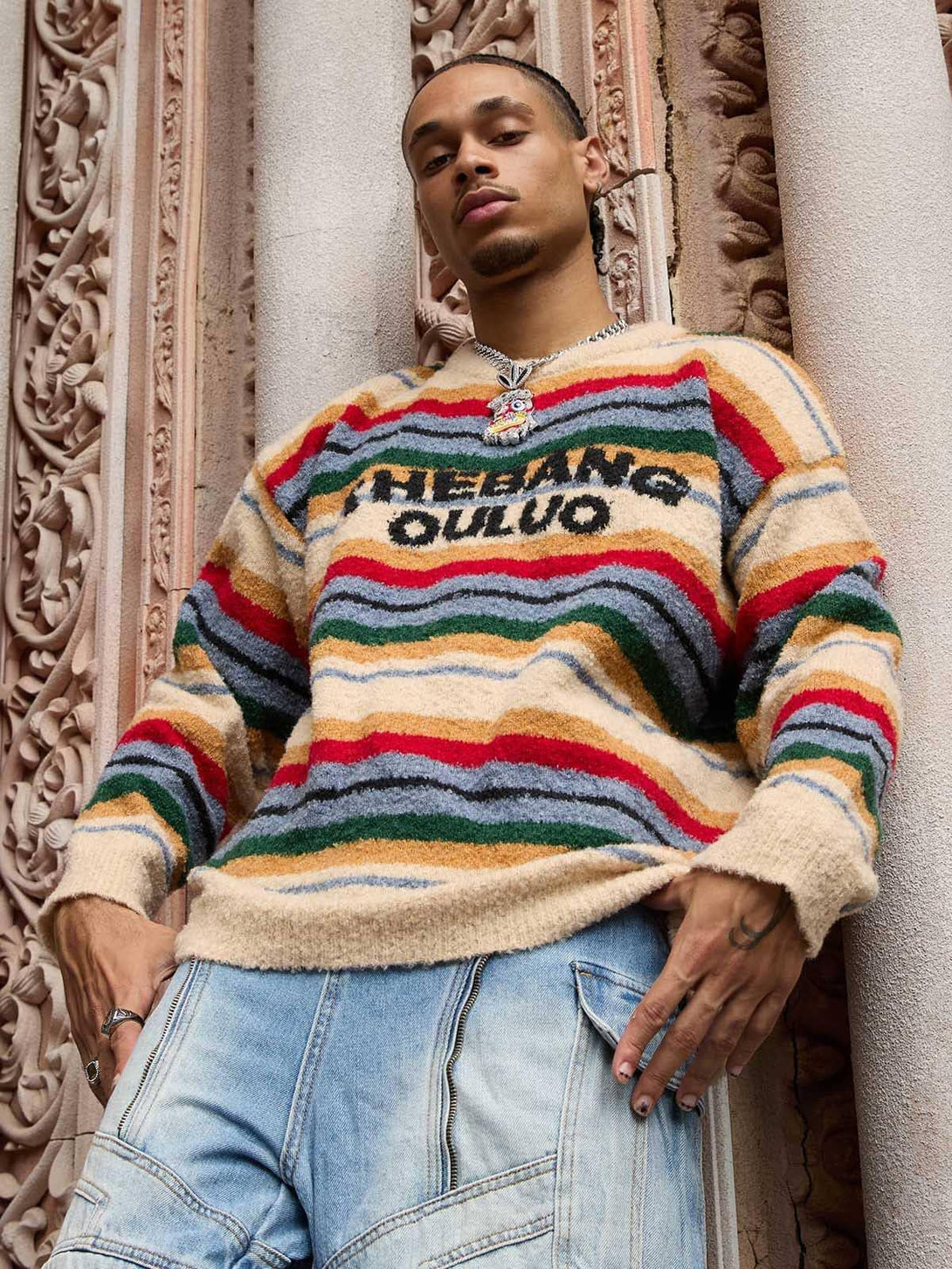 Model in a TALISHKO vintage striped sweater, showcasing vibrant colors and bold style.