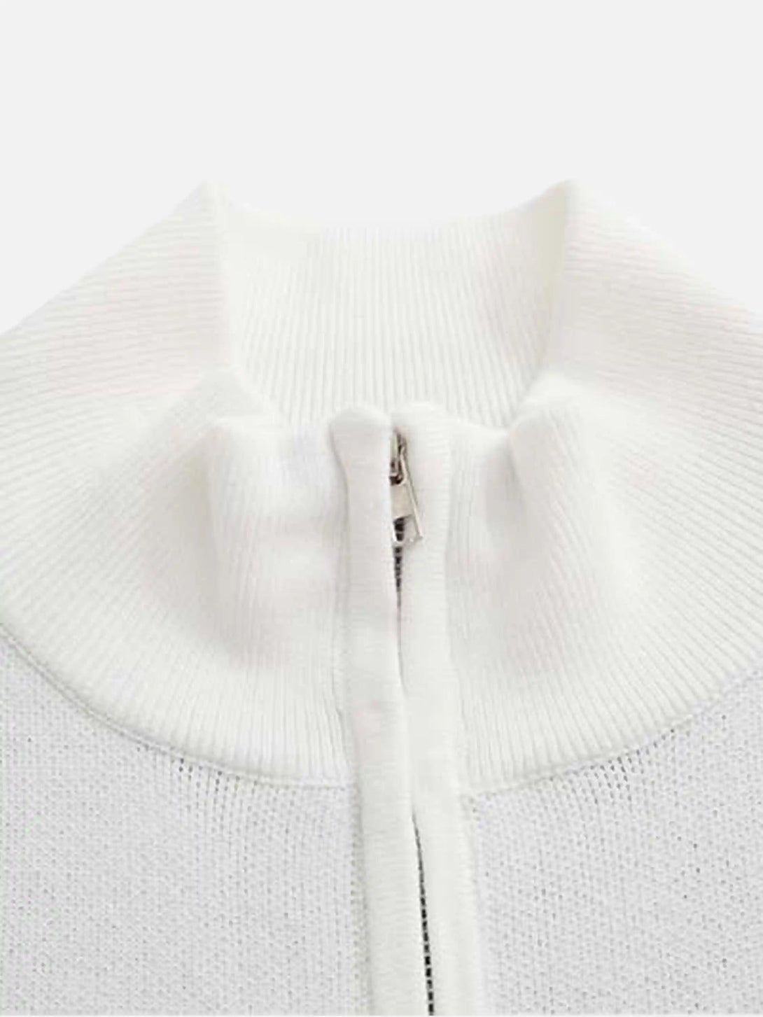 A close-up of the white stand collar on a TALISHKO cardigan, highlighting its ribbed texture.