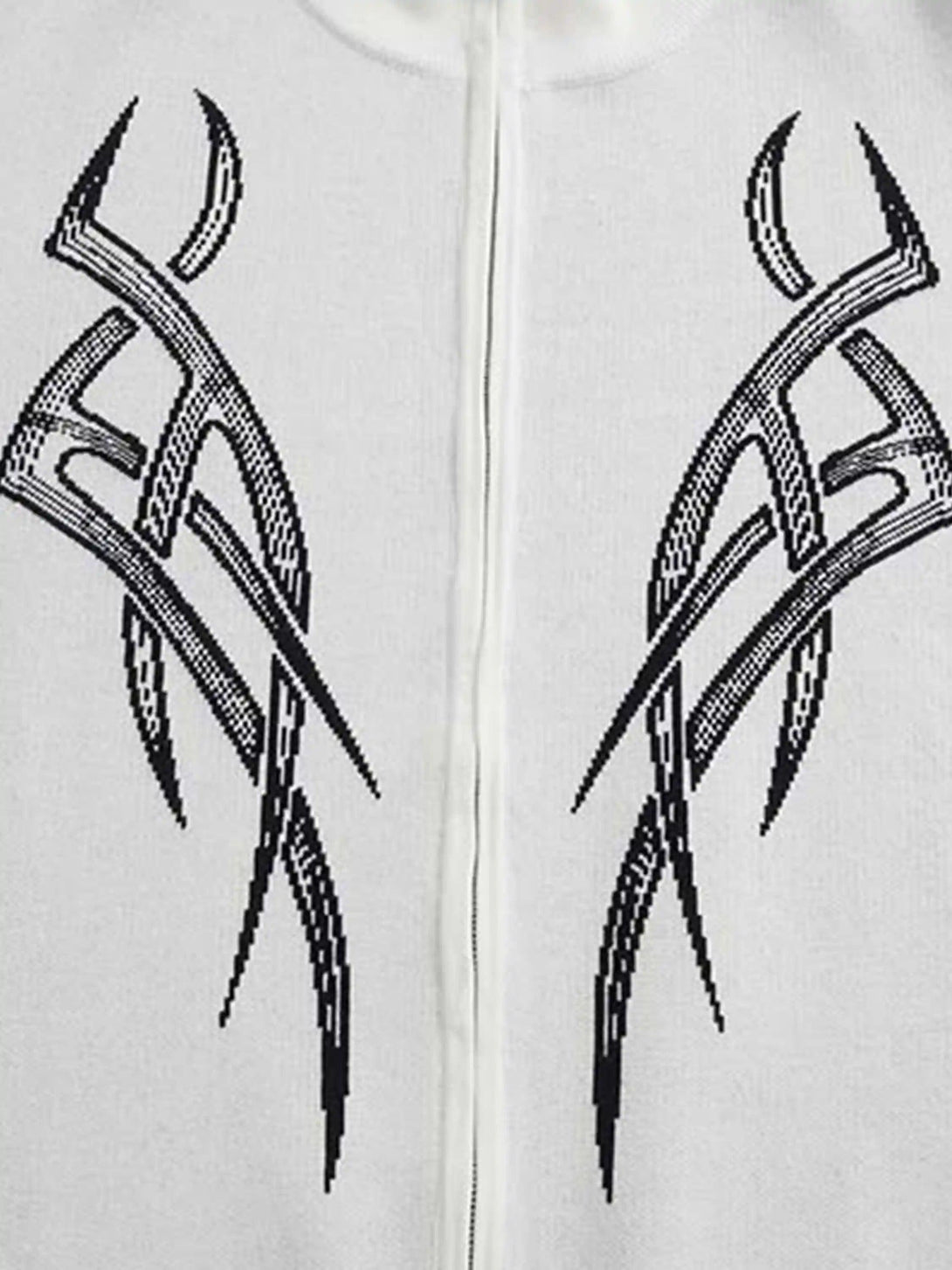 Thorn patterns on a white TALISHKO cardigan, showcasing bold design details.