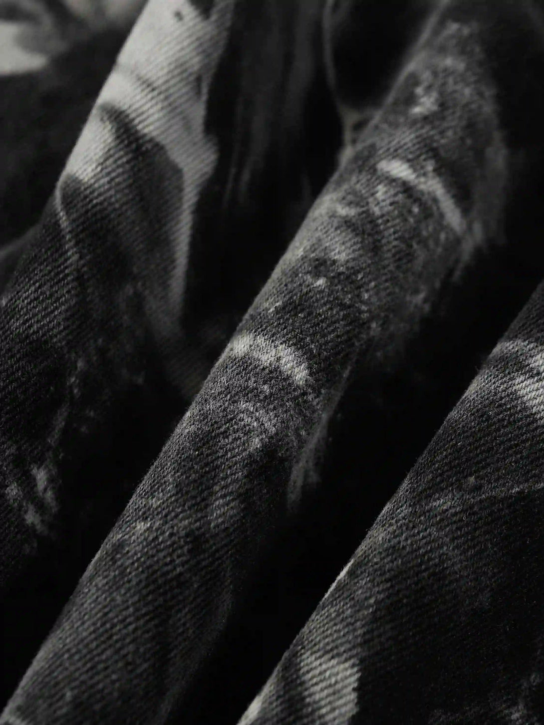 Texture and pattern showcased on TALISHKO's vintage tie-dye denim jacket fabric.