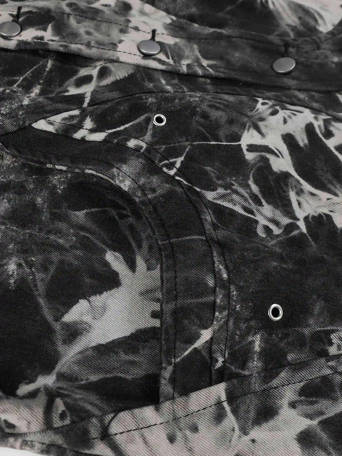 Detailed fabric and stitching on TALISHKO's vintage tie-dye denim jacket, highlighting its unique texture.