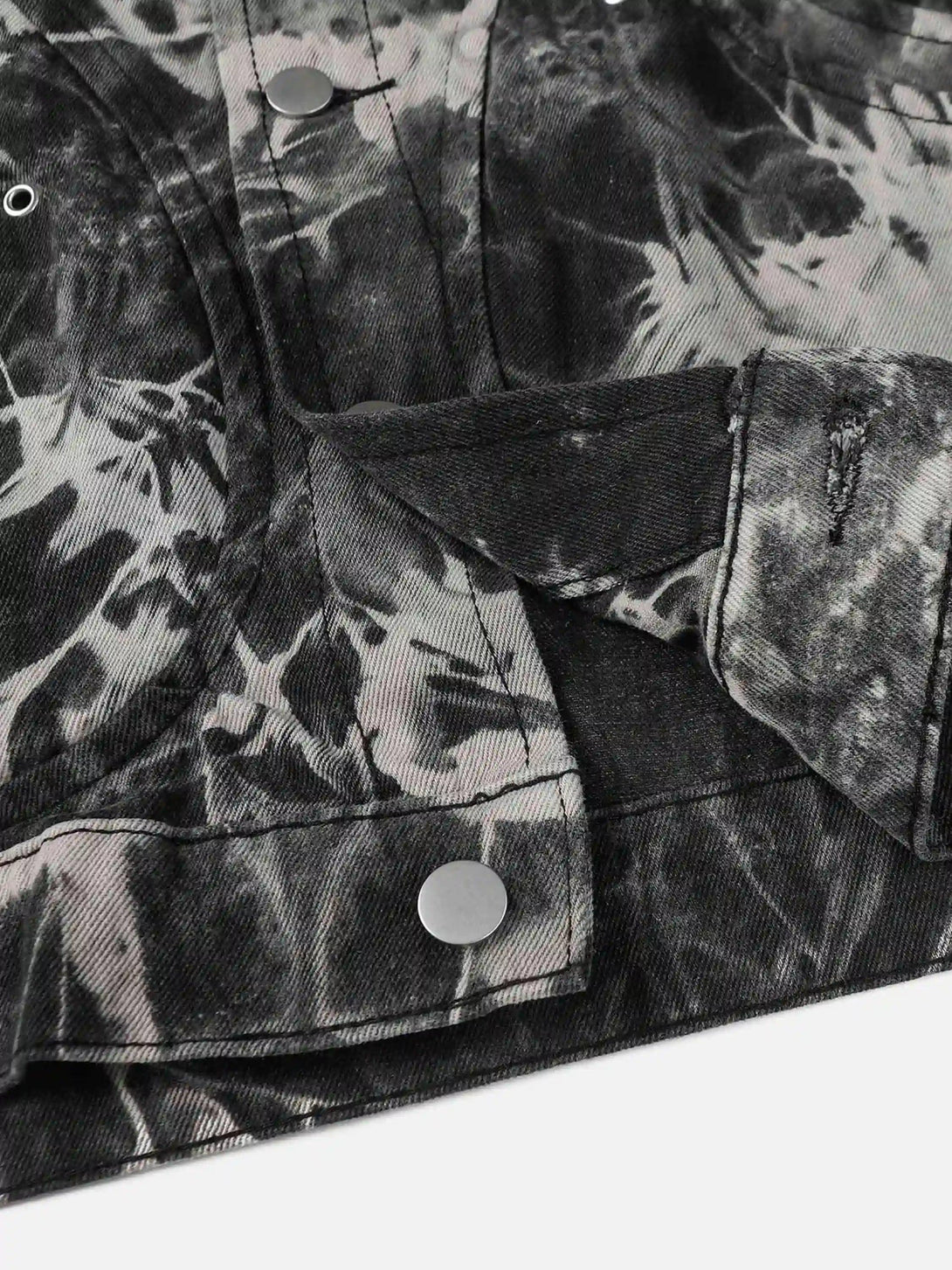 Detailed view of TALISHKO's vintage tie-dye denim jacket, highlighting unique button design.