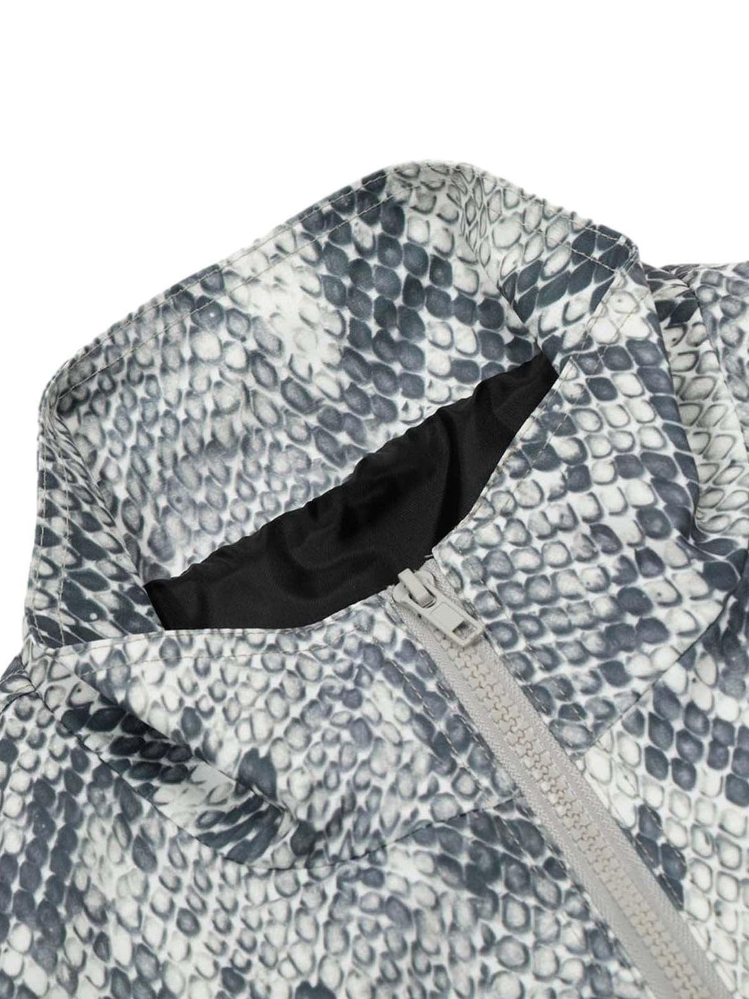 A tight crop highlighting the TALISHKO windbreaker jacket's snakeskin texture and sleek zipper.