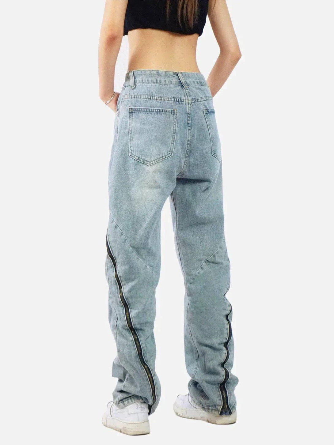 Back view of vintage wash adjustable zip jeans by TALISHKO, paired with casual white sneakers.